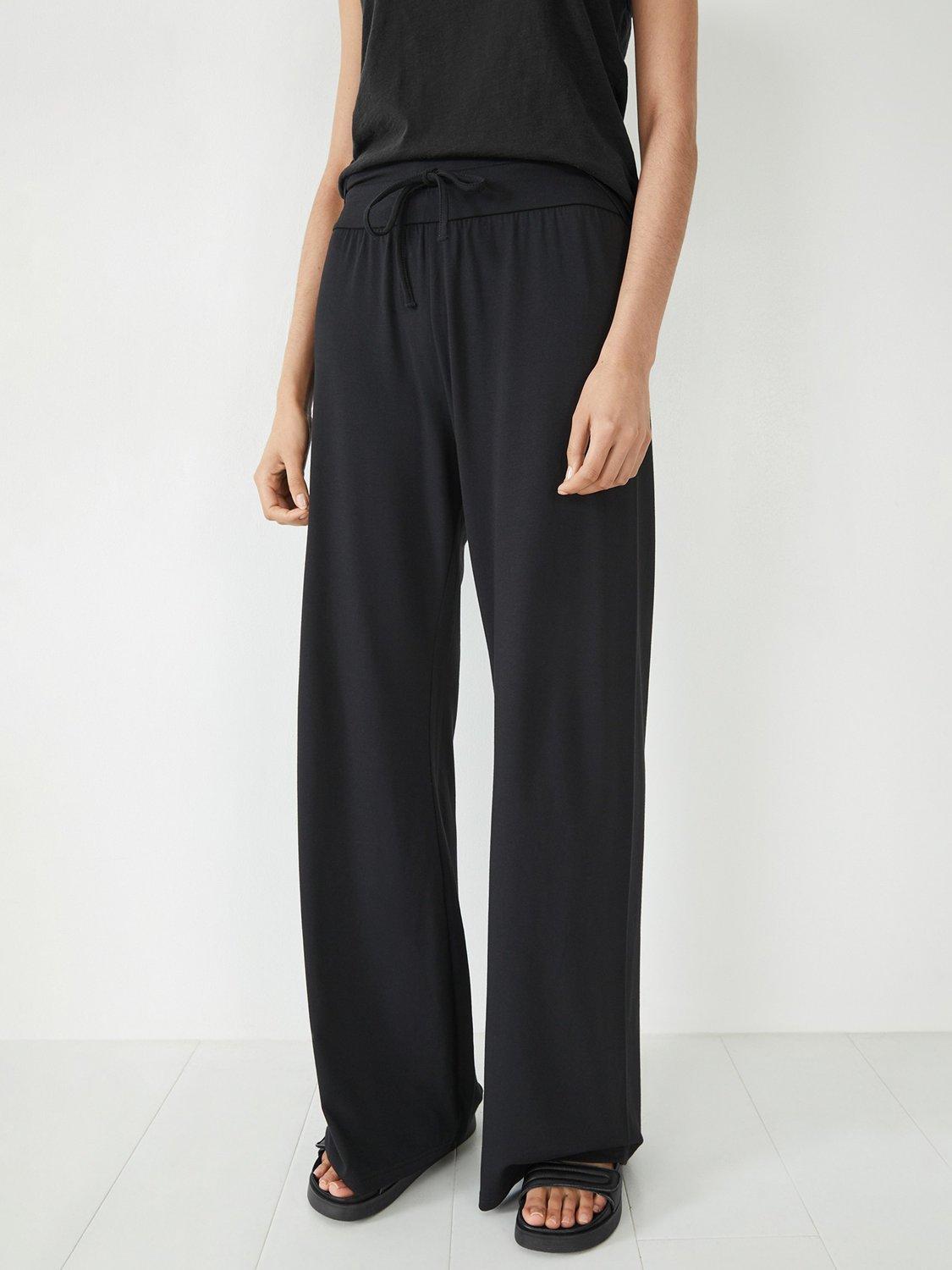 Product image 1 of 4, which shows HUSH Amie Wide Leg Joggers, Black, L-XL