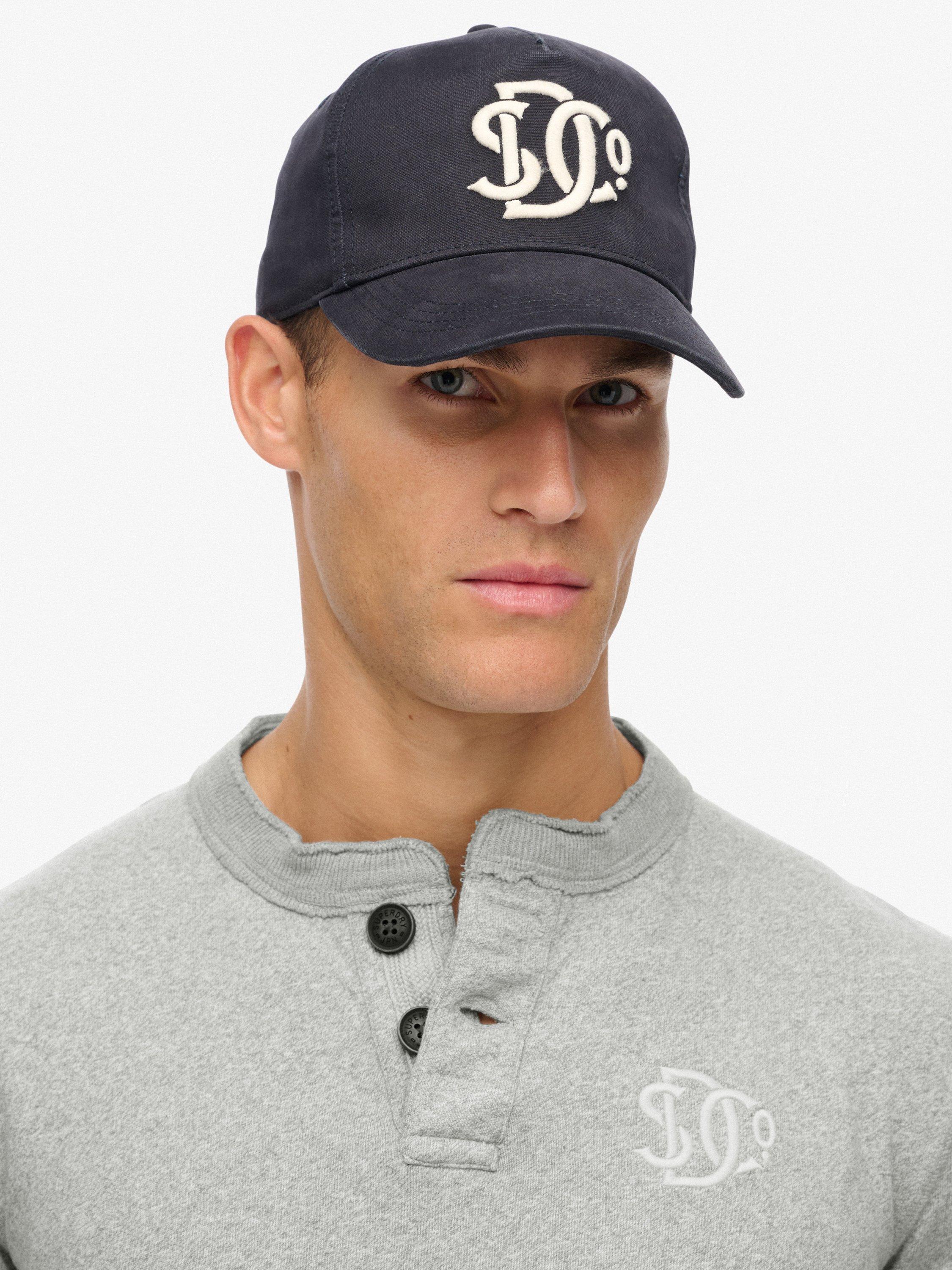 Product image 2 of 4, which shows Superdry Monogram Trucker Baseball Cap, Eclipse Navy, One Size