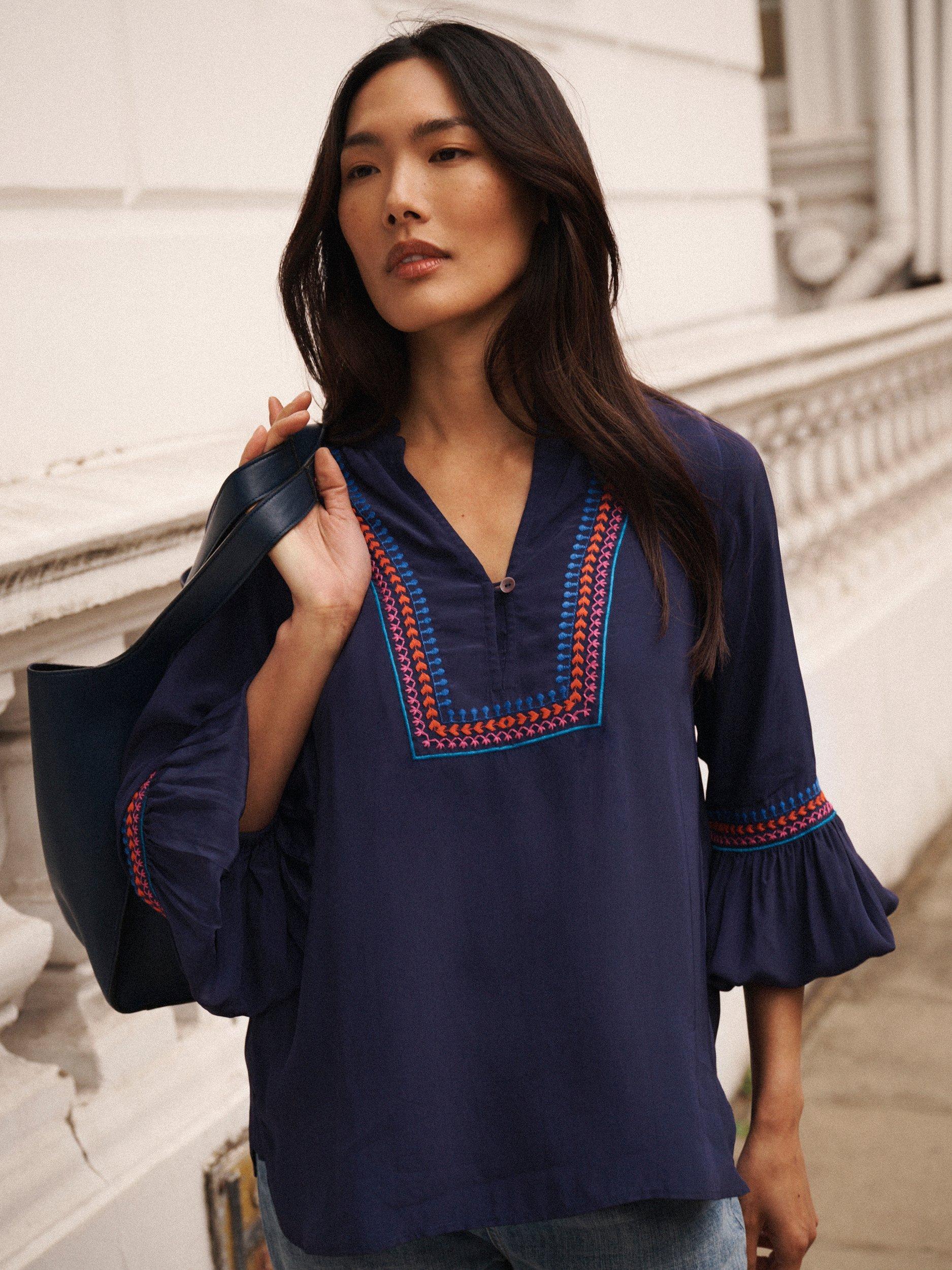 Product image 1 of 8, which shows NRBY Vaila Embroidered Long Sleeve V Neck Blouse, Navy, XS