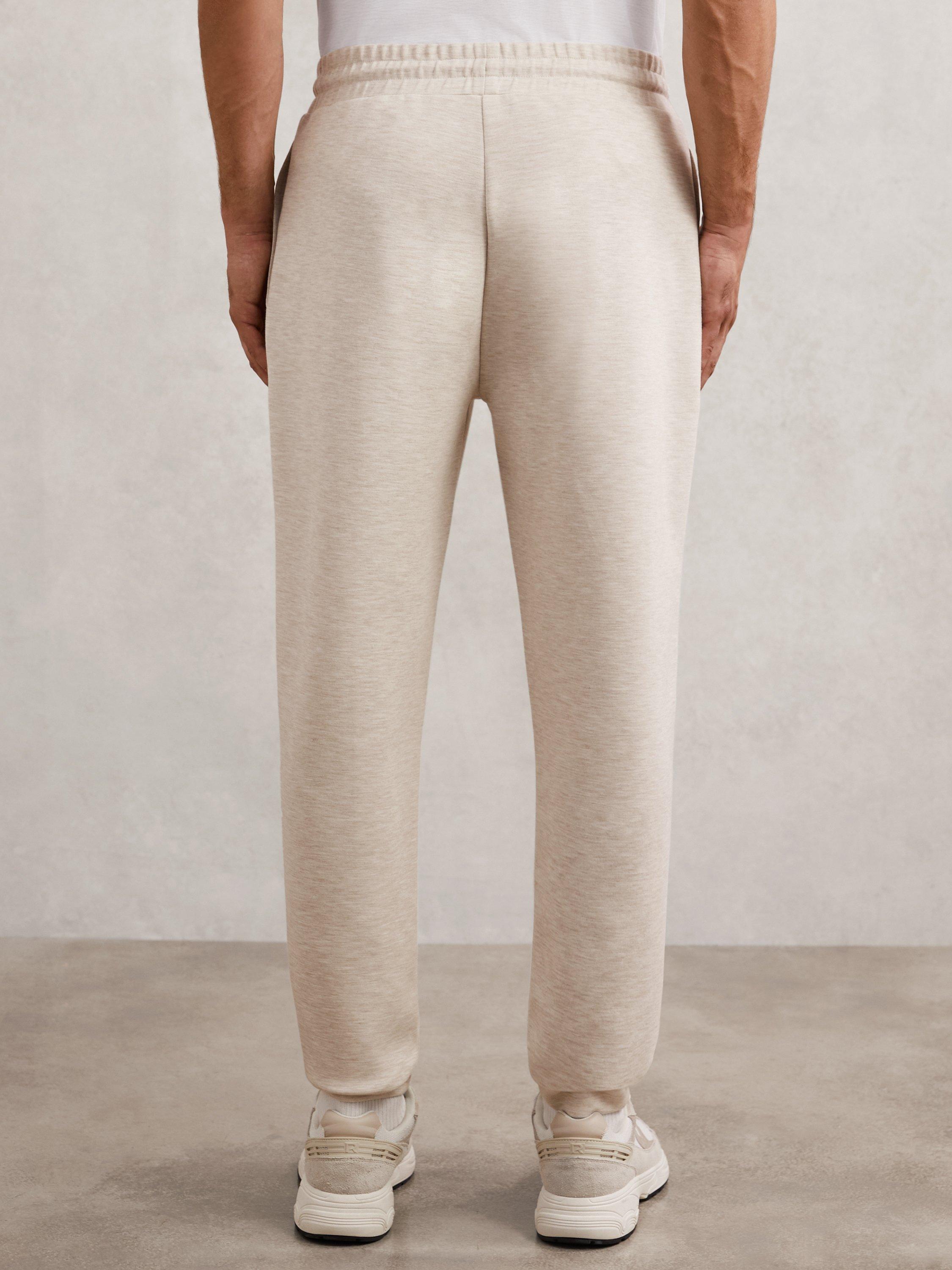 Product image 2 of 5, which shows Reiss Bell Jersey Drawstring Cuffed Joggers, Oatmeal, XS