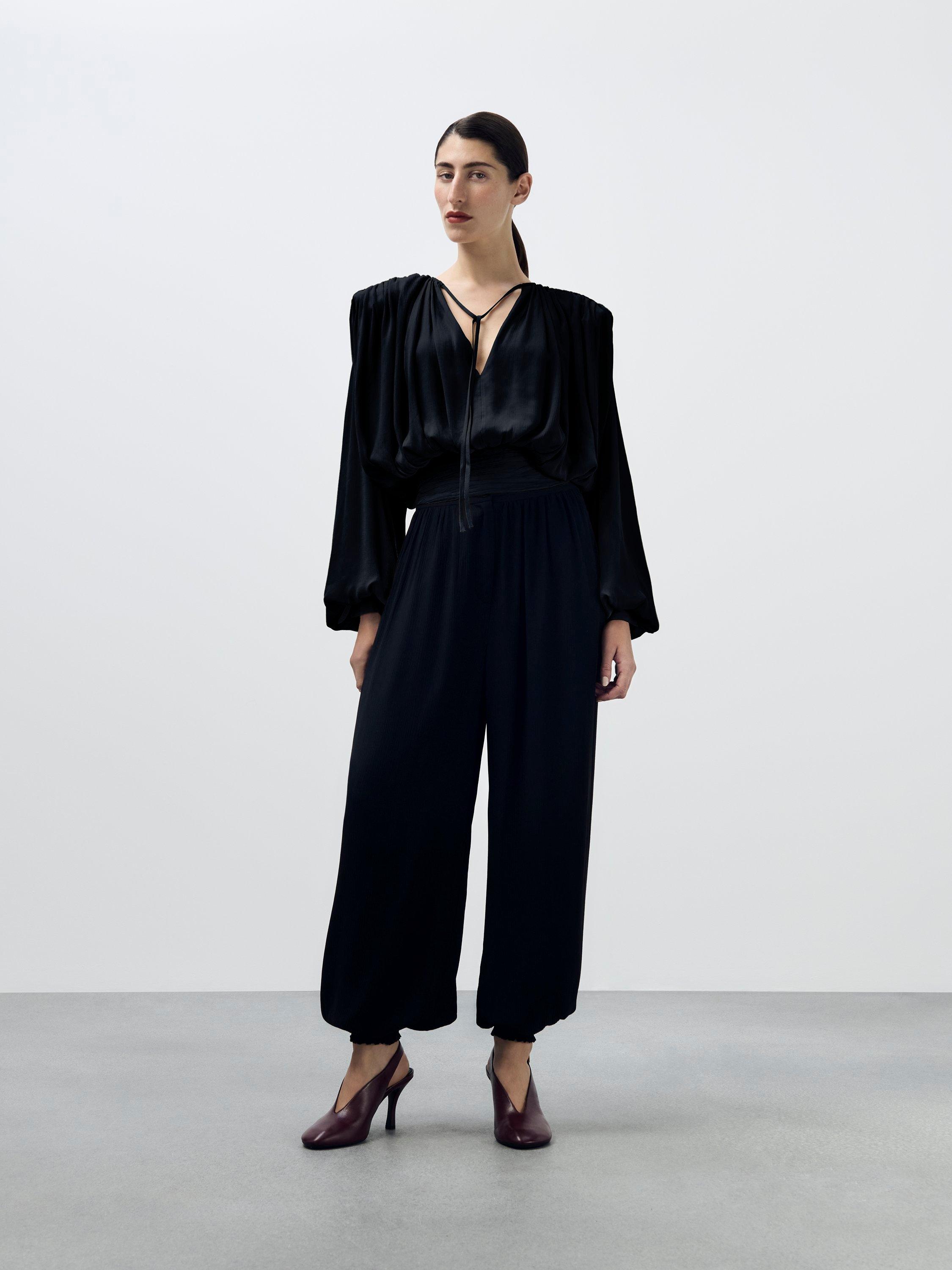 Product image 8 of 8, which shows AND/OR Textured Tie Neck Top, Black, 6