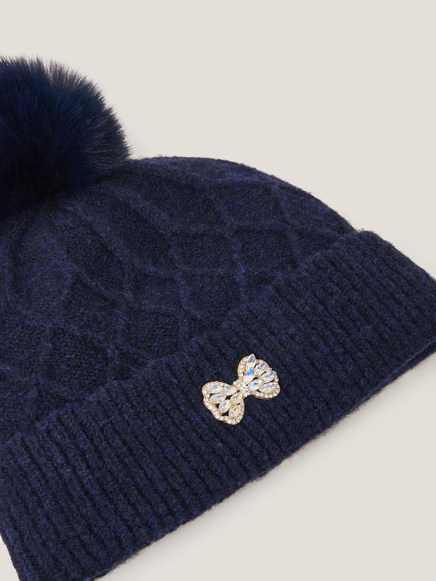 Product image 2 of 2, which shows Monsoon Kids' Diamond Bow Pom Pom Beanie Hat, Navy, 3-6 years