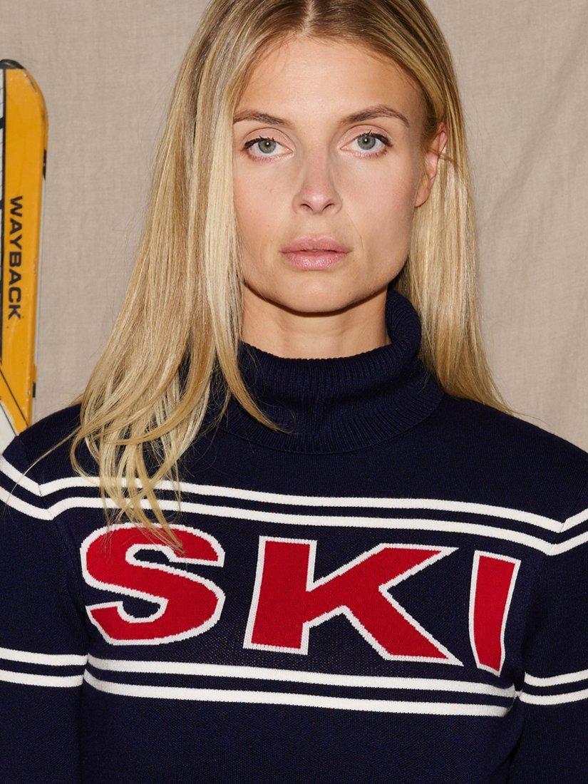 Product image 2 of 6, which shows The Little Tailor Slim Roll Neck Ski Text Jumper, Navy/Red, XS