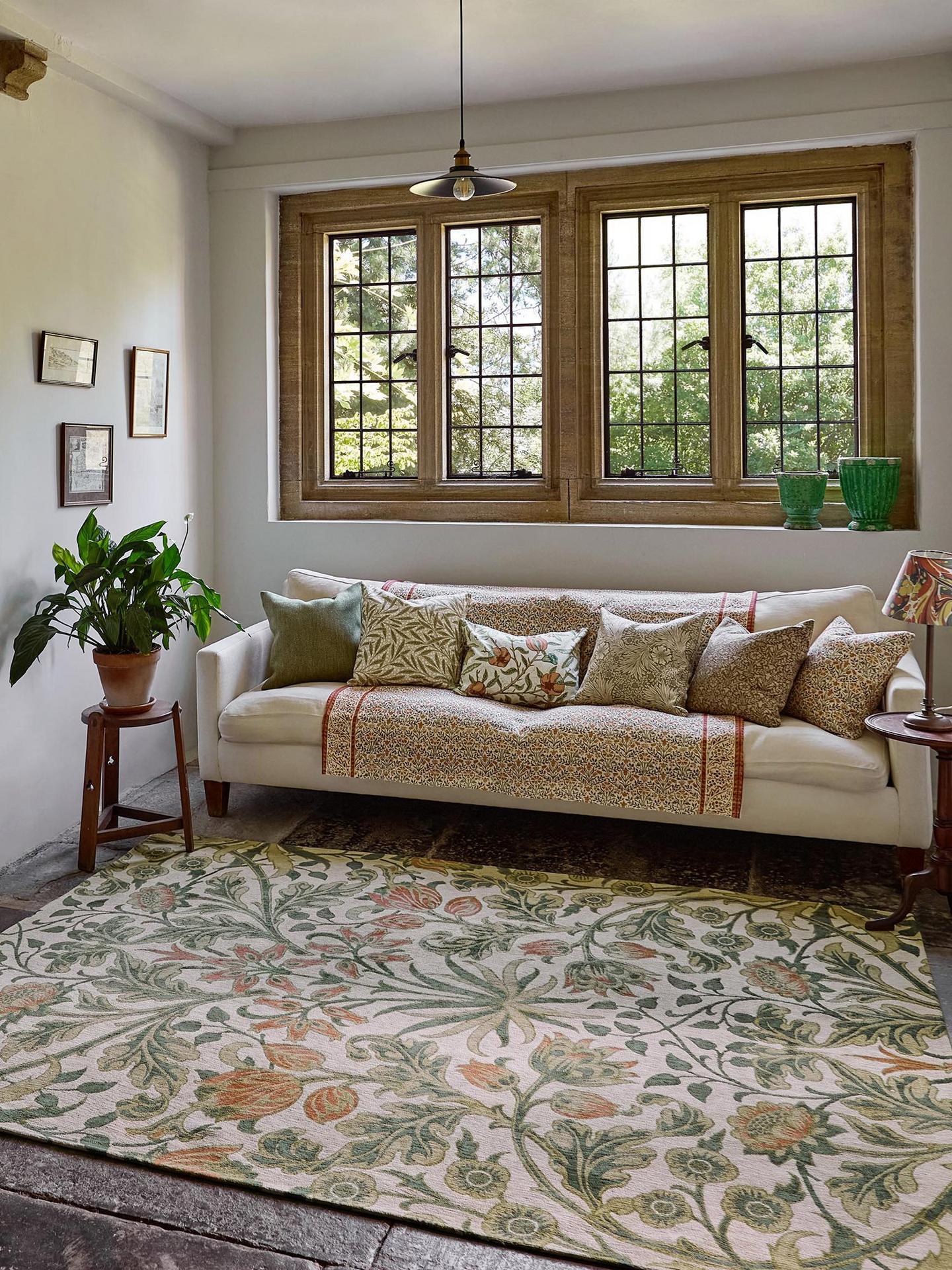 Boho-themed living room with Morris and Co.’s floral rug