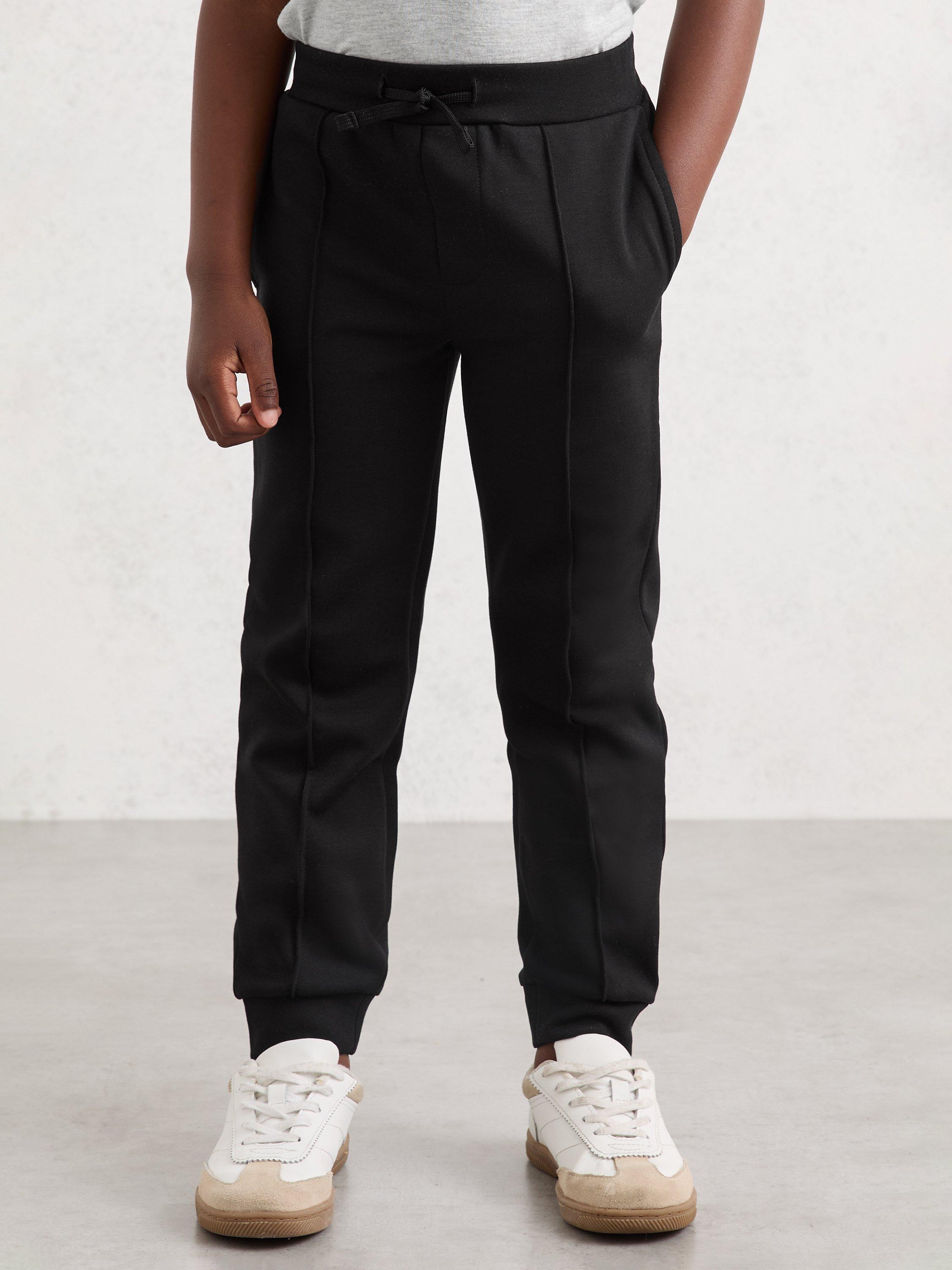Product image 1 of 4, which shows Reiss Kids' Premier Tapered Drawstring Joggers, Black, 3-4 years