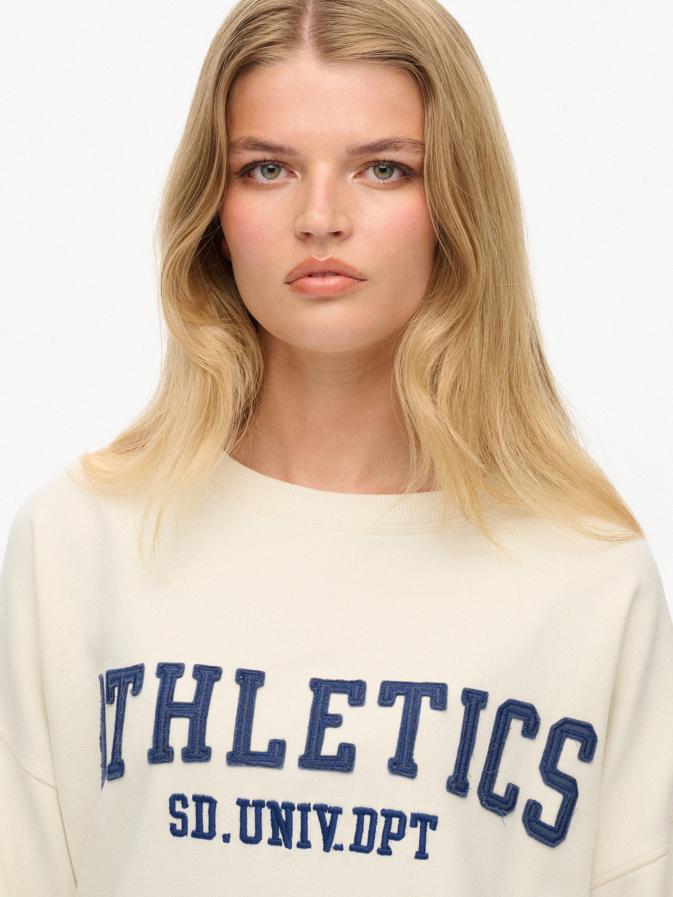 Product image 5 of 6, which shows Superdry Athletic Essentials Applique Crew Sweatshirt, Desert Bone Offwhite, 16