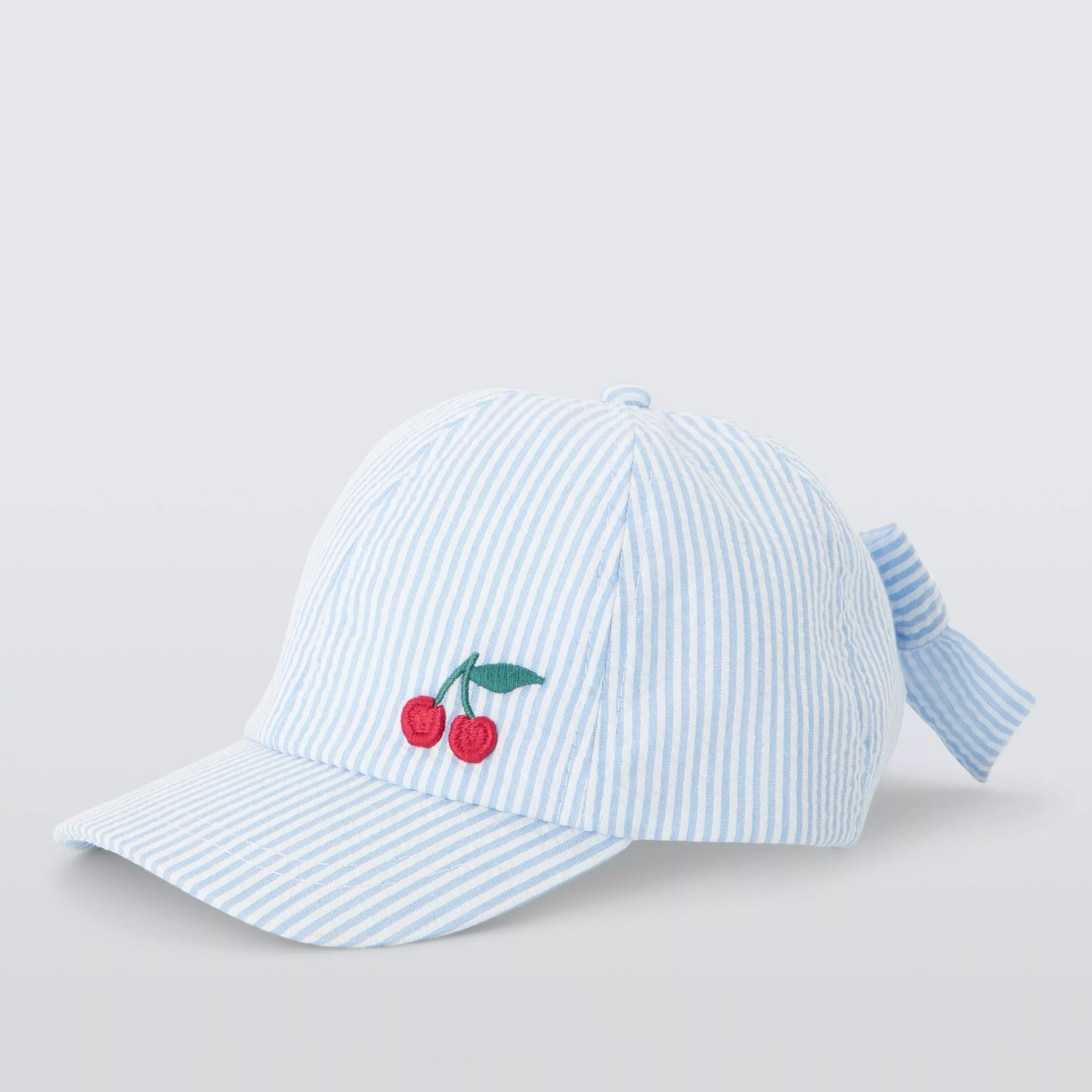 Light blue and white striped seersucker baseball cap with embroidered cherry motif and back bow detail