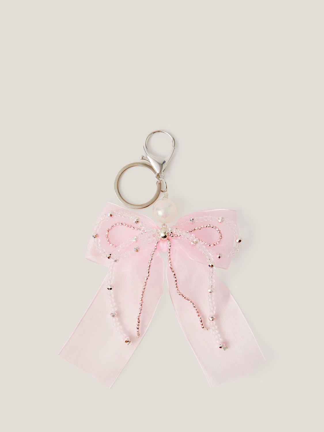 Product image 1 of 3, which shows Monsoon Kids' Bead & Ribbon Bow Bag Charm, Ivory