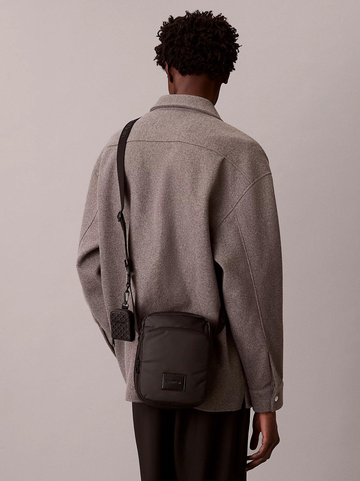 Product image 5 of 5, which shows Calvin Klein Puffer Utility Reporter Bag, Black, One Size