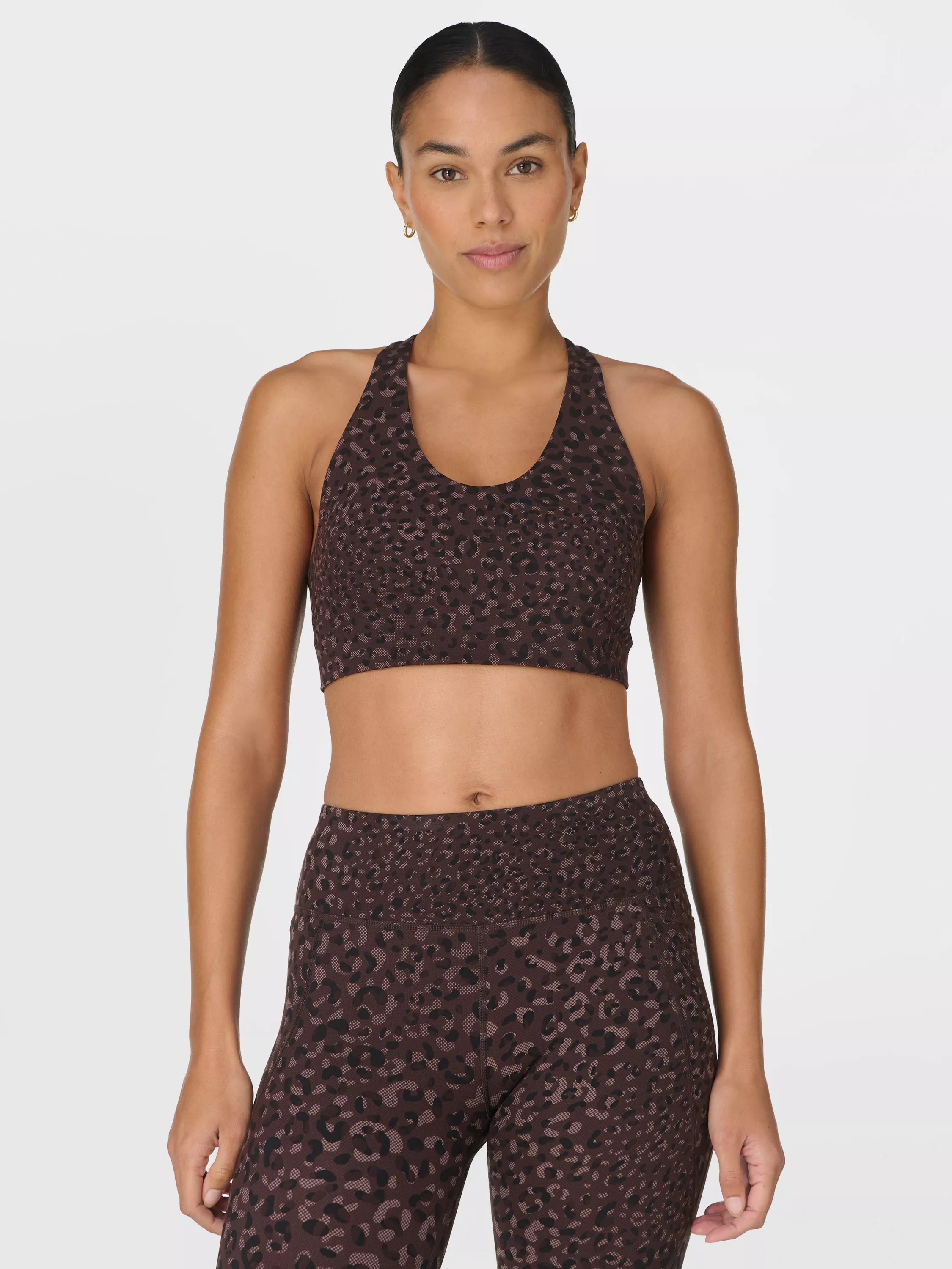 woman wearing brown printed gym bra and matching leggings