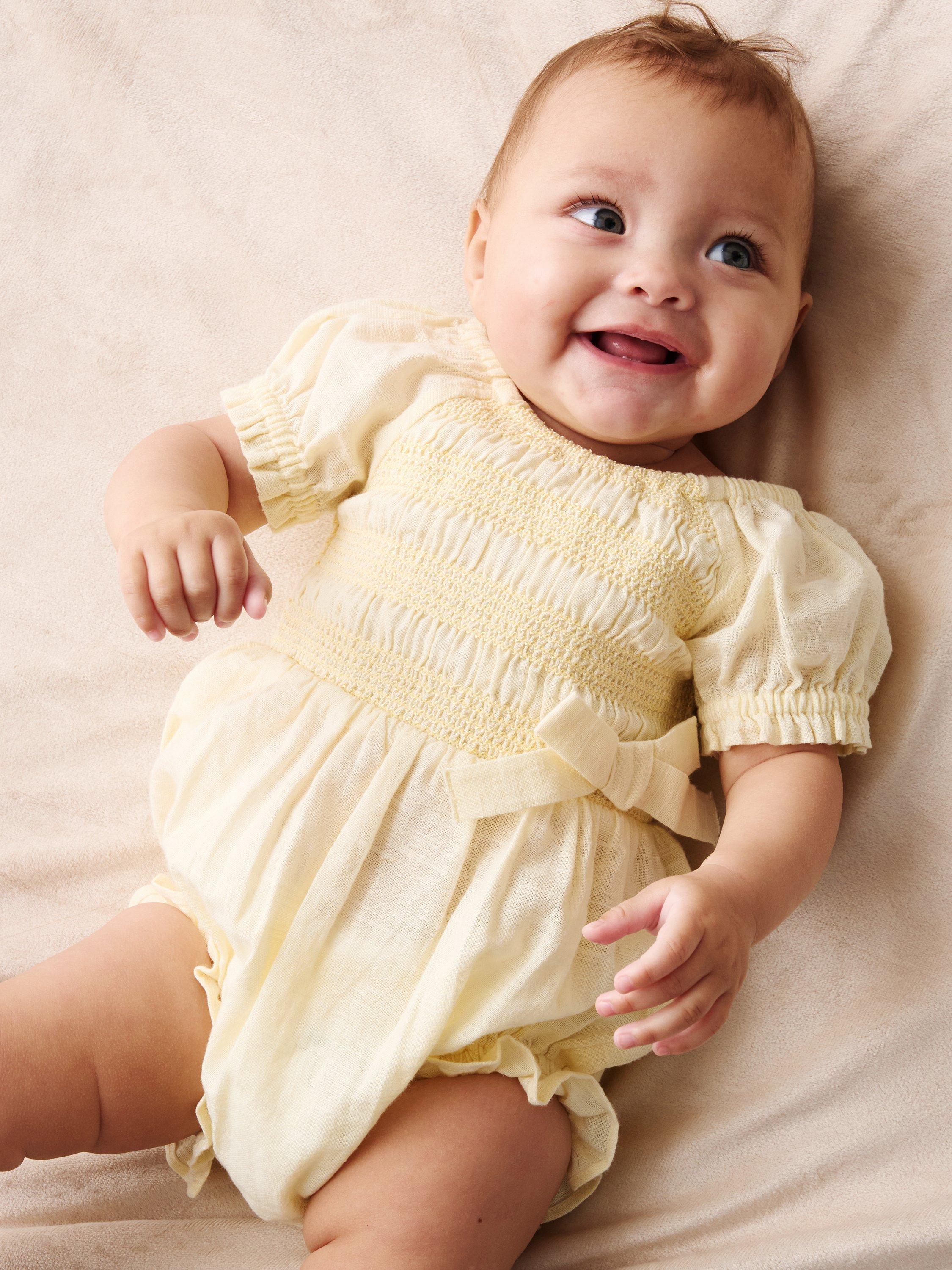 Product image 1 of 4, which shows Angel & Rocket Baby Cotton Shirred Romper, Yellow, 0-3 months