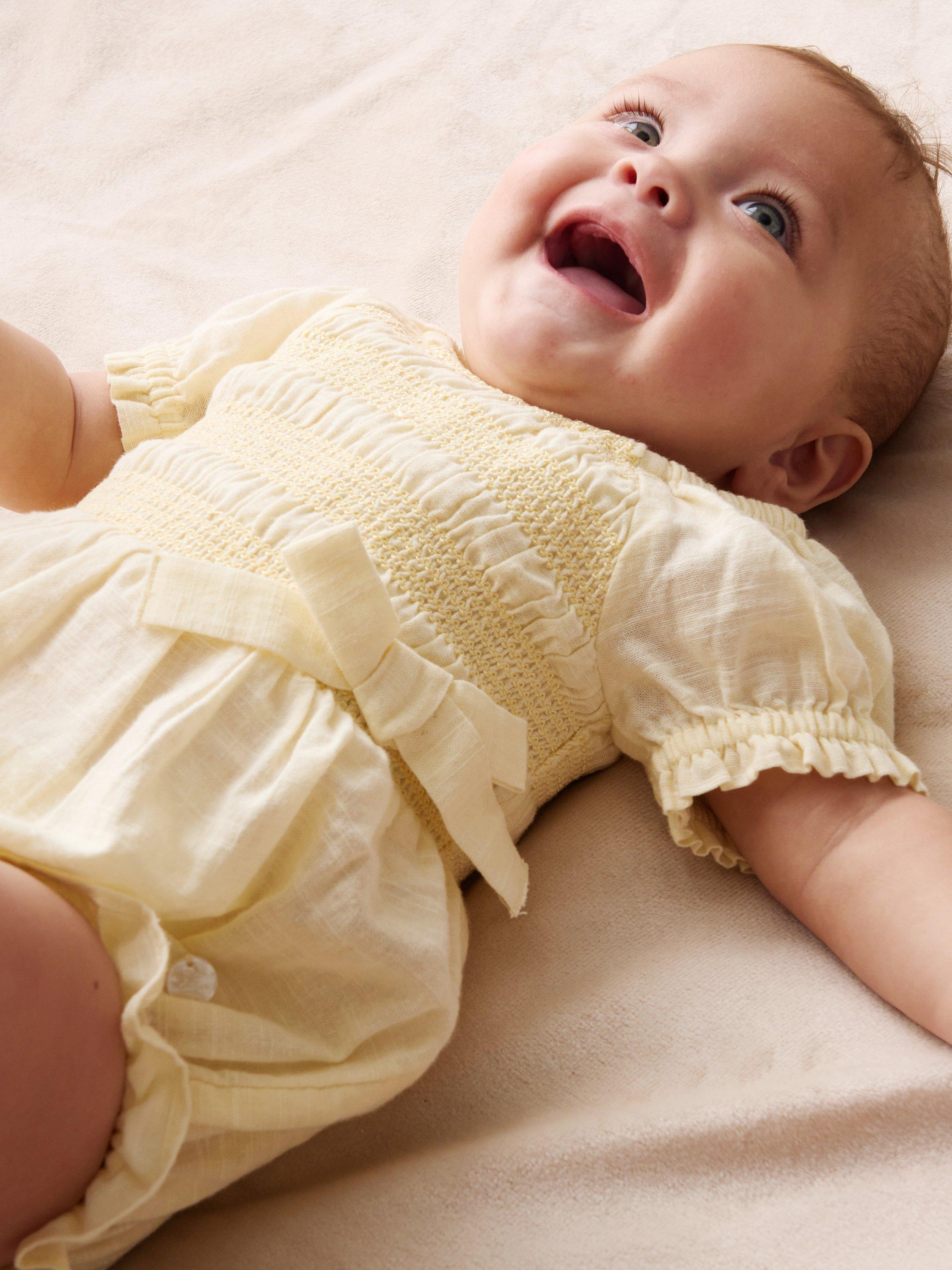 Product image 2 of 4, which shows Angel & Rocket Baby Cotton Shirred Romper, Yellow, 0-3 months