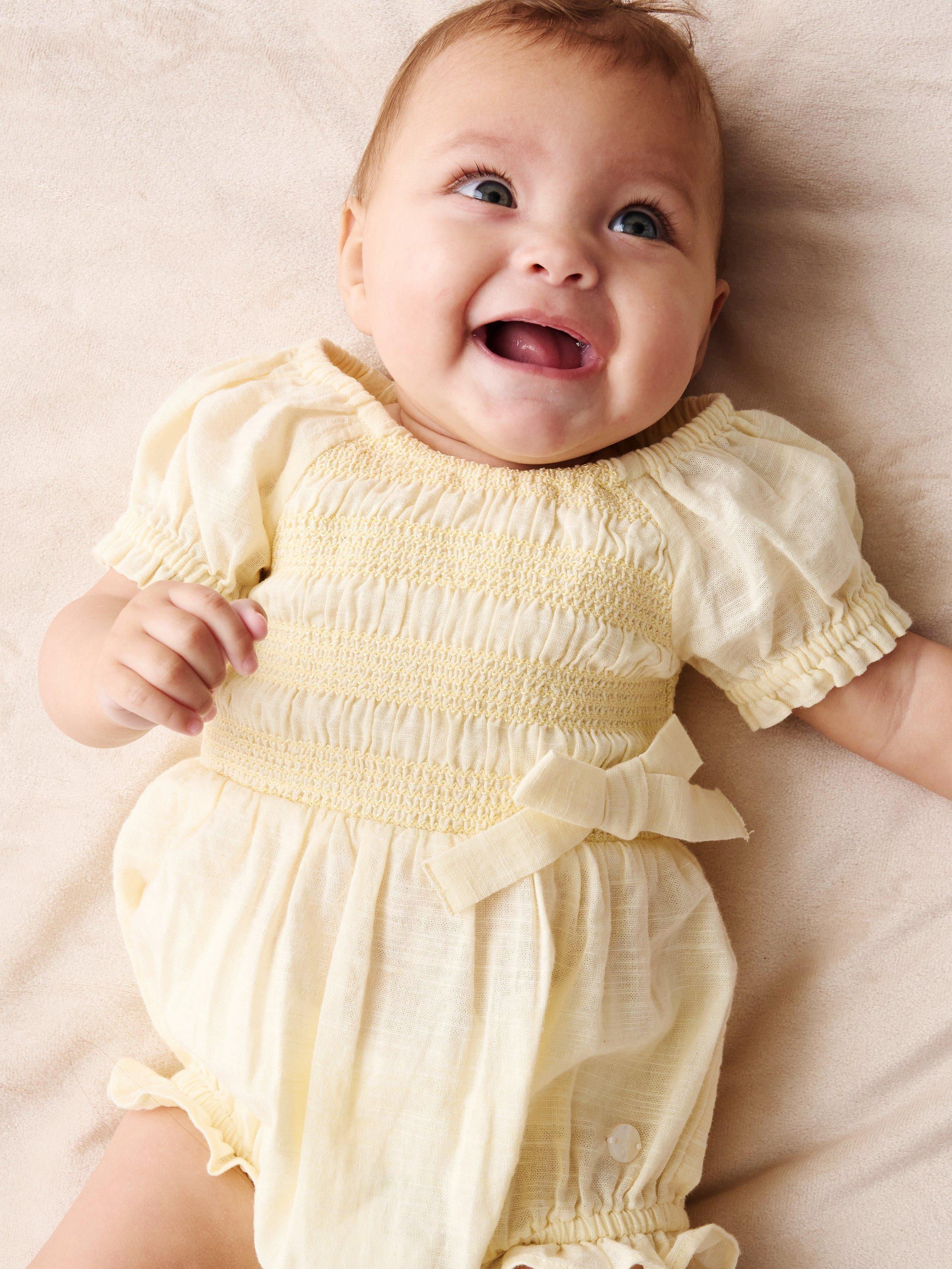 Product image 3 of 4, which shows Angel & Rocket Baby Cotton Shirred Romper, Yellow, 0-3 months