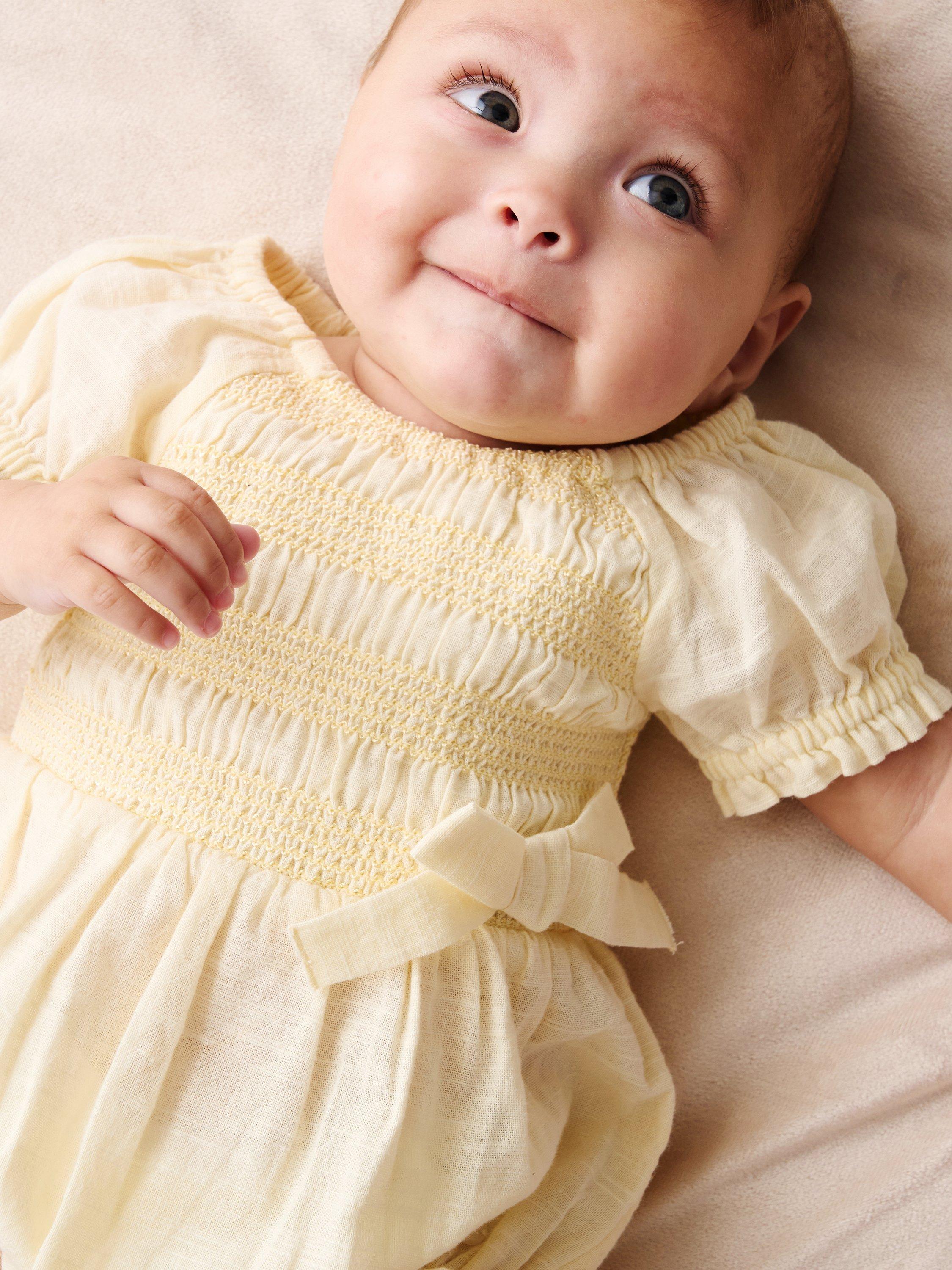 Product image 4 of 4, which shows Angel & Rocket Baby Cotton Shirred Romper, Yellow, 0-3 months