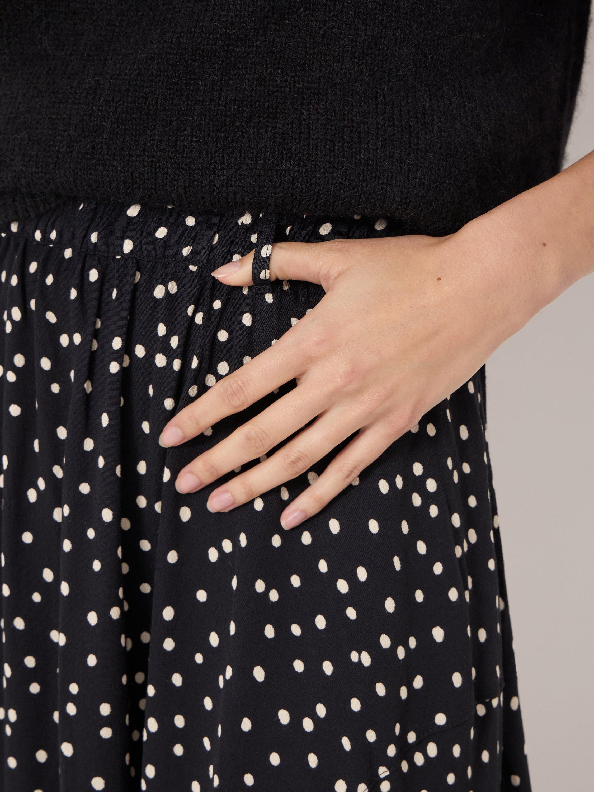 Product image 5 of 6, which shows HUSH Cesca Polka Dot Asymmetric Skirt, Black/White, L-XL
