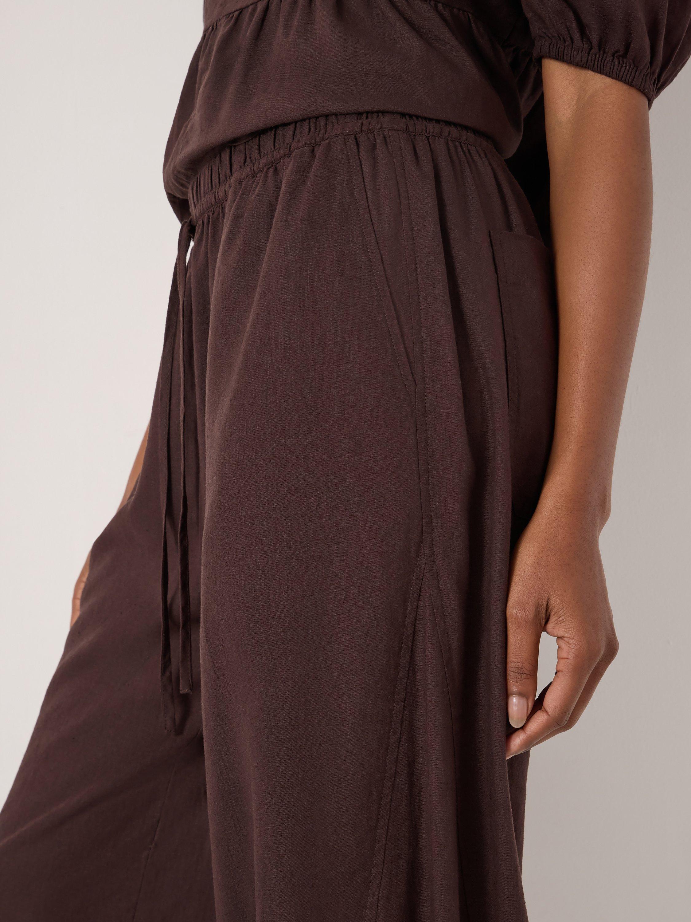Product image 7 of 7, which shows HUSH Tove Beach Trousers, Dark Brown, L-XL