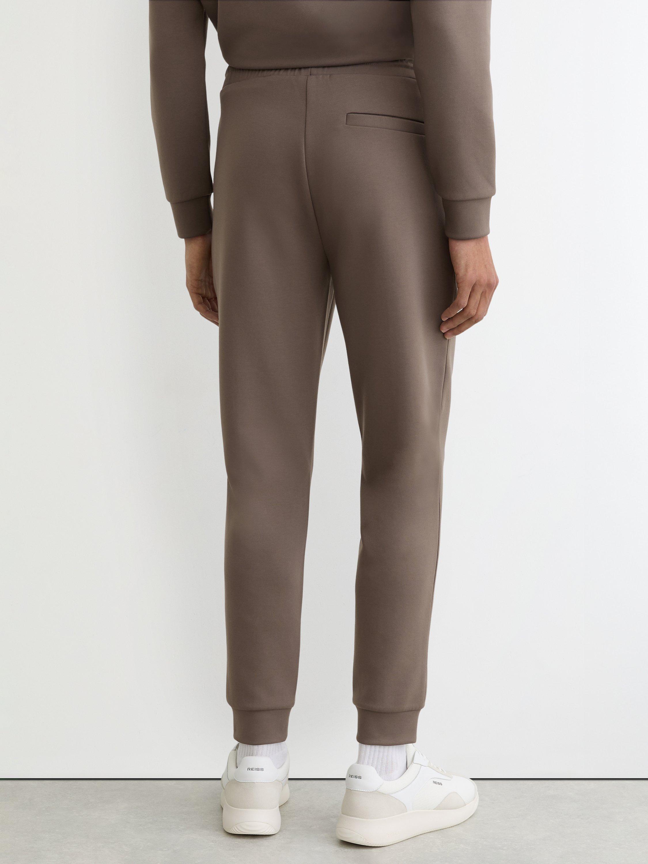 Product image 2 of 5, which shows Reiss Premier Premium Interlock Jersey Joggers, Light Brown, XS