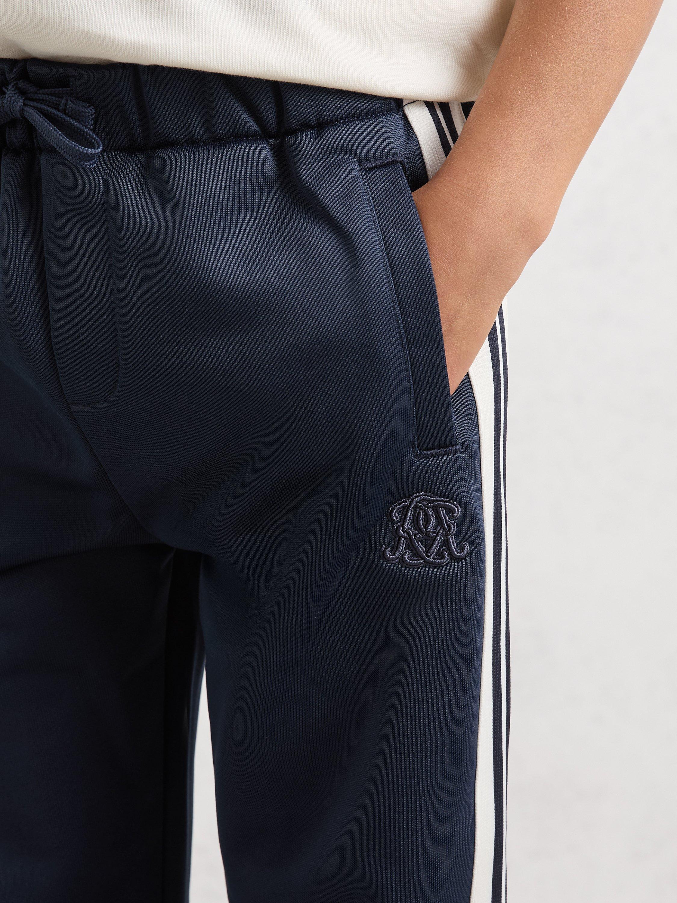 Product image 5 of 5, which shows Reiss Kids' Foster Monogram Side Stripe Joggers, Navy Blue, 3-4 years