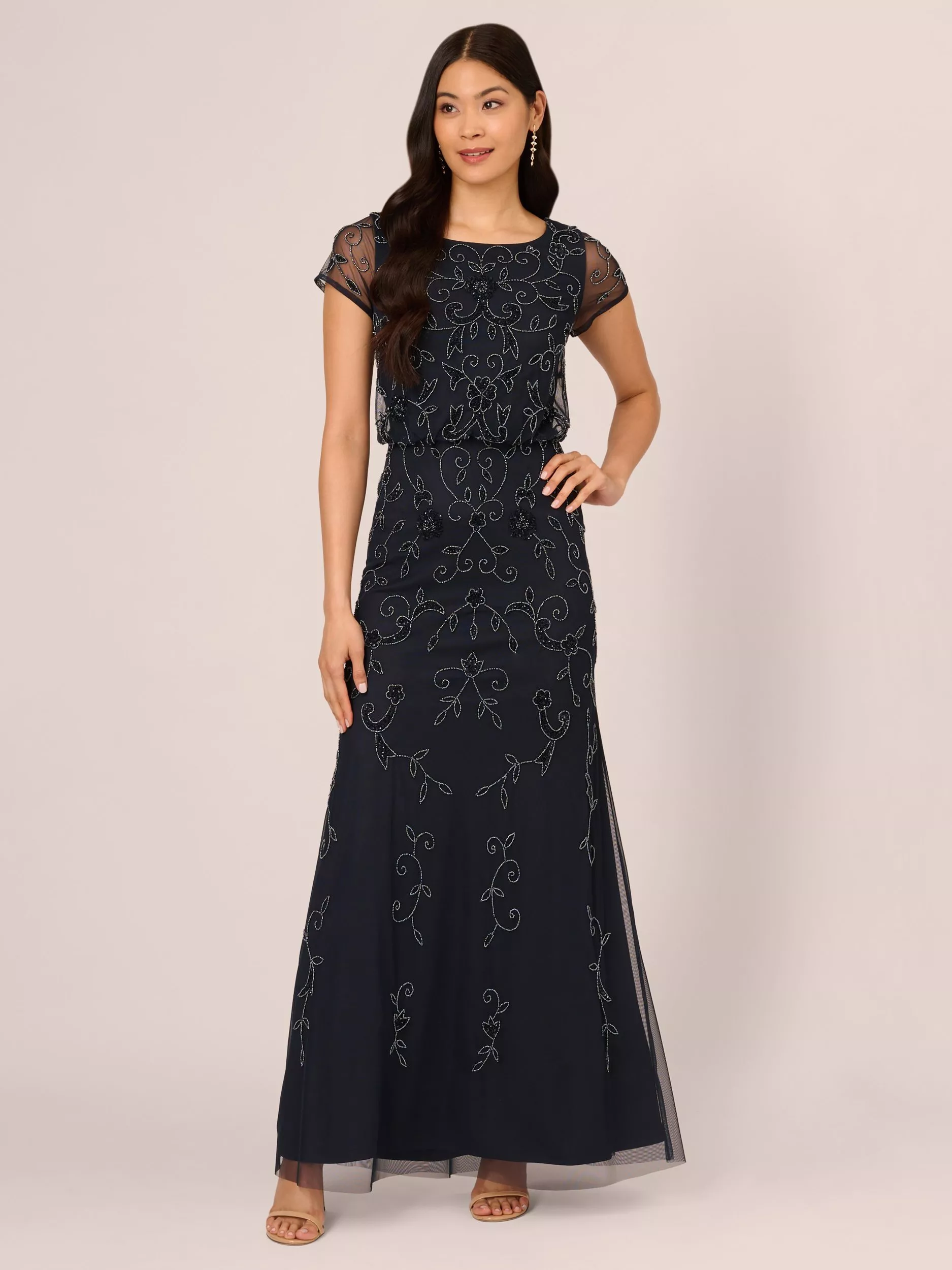 woman in brown halterneck maxi dress with silver pointed heels