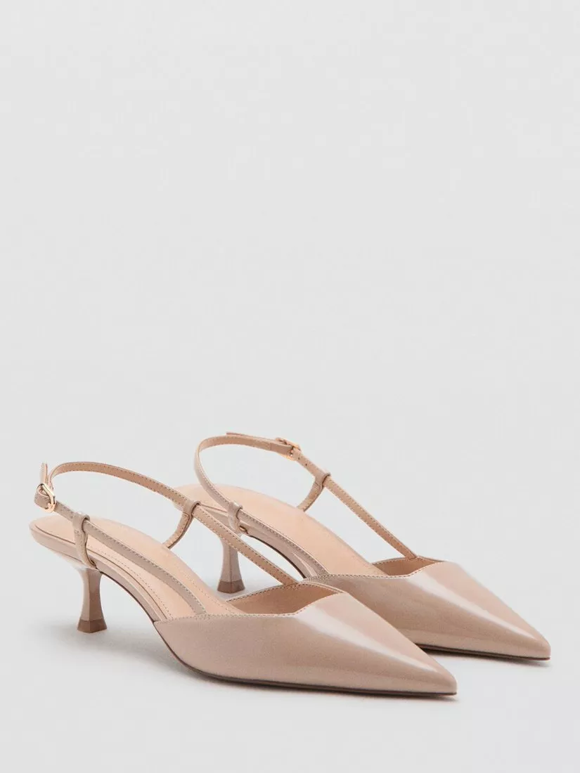 Beige patent leather slingback kitten heel shoes with pointed toe, minimalist design, on a white background
