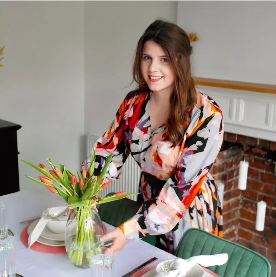 woman putting tulips on dining room table