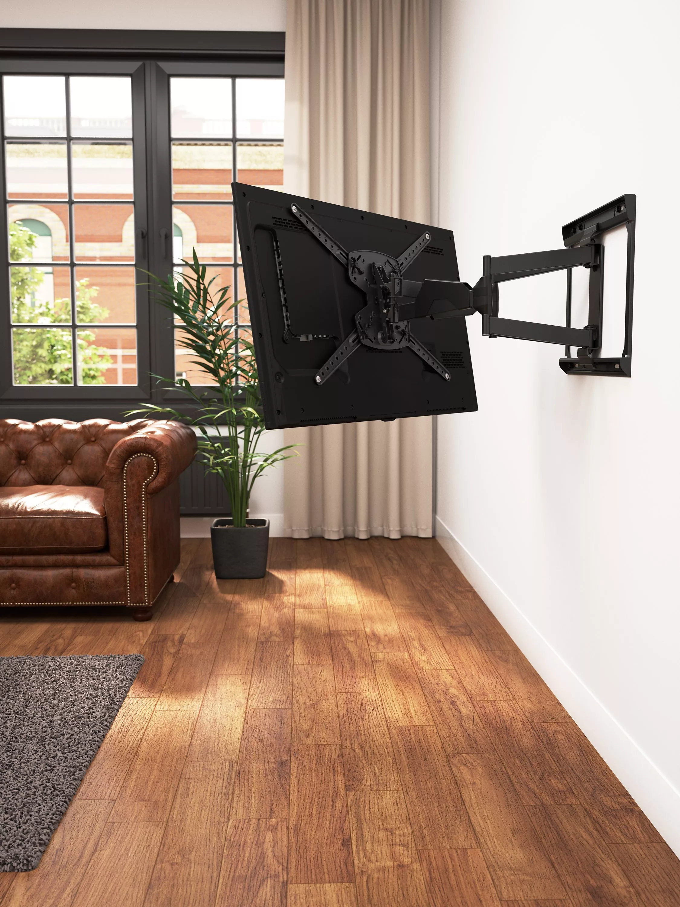 Articulating wall-mounted TV bracket with flat screen in modern living room beside window and leather sofa