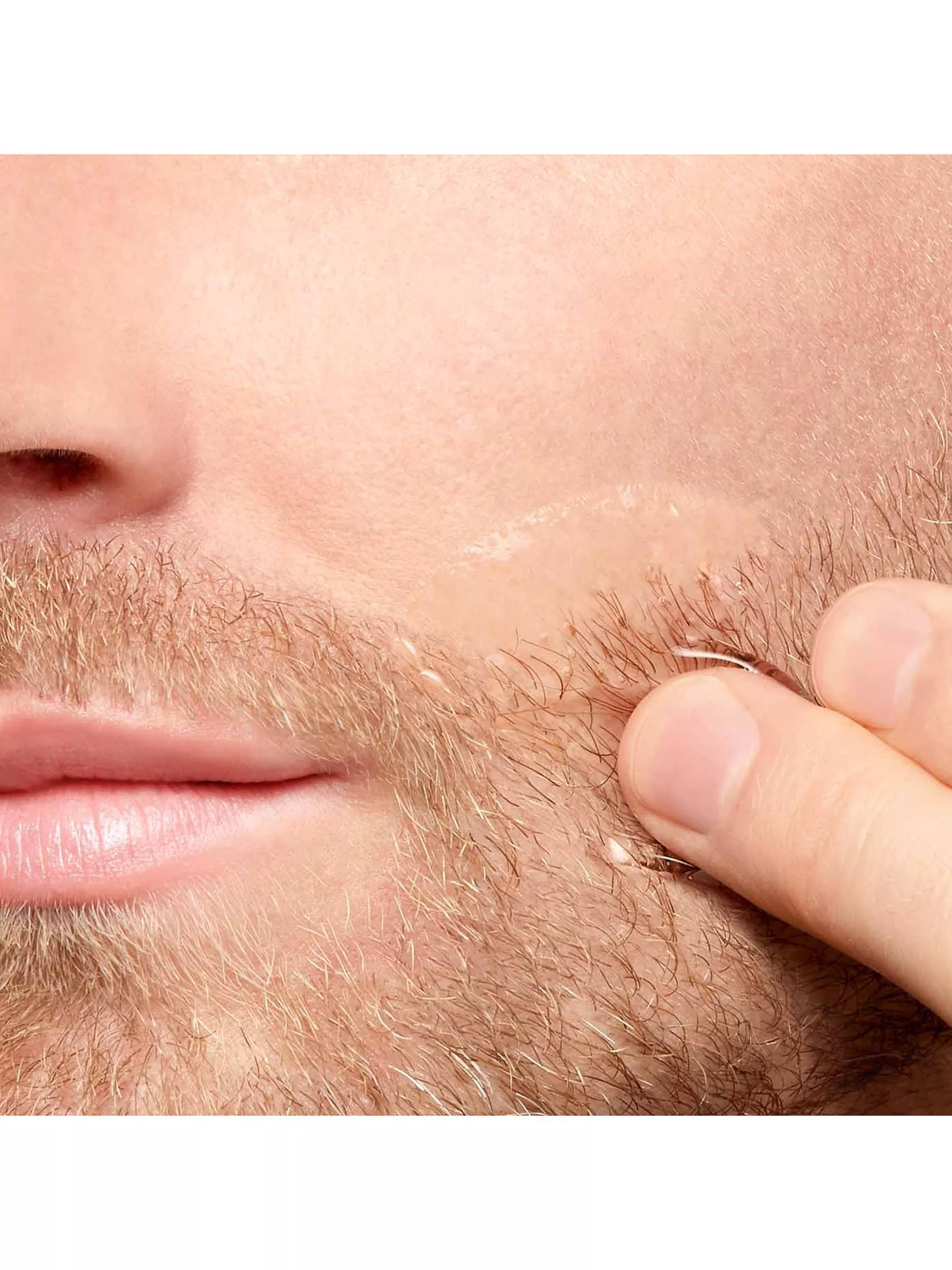 man using toner on face