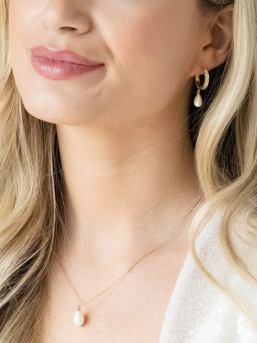 woman wearing a pearl earring and pearl necklace