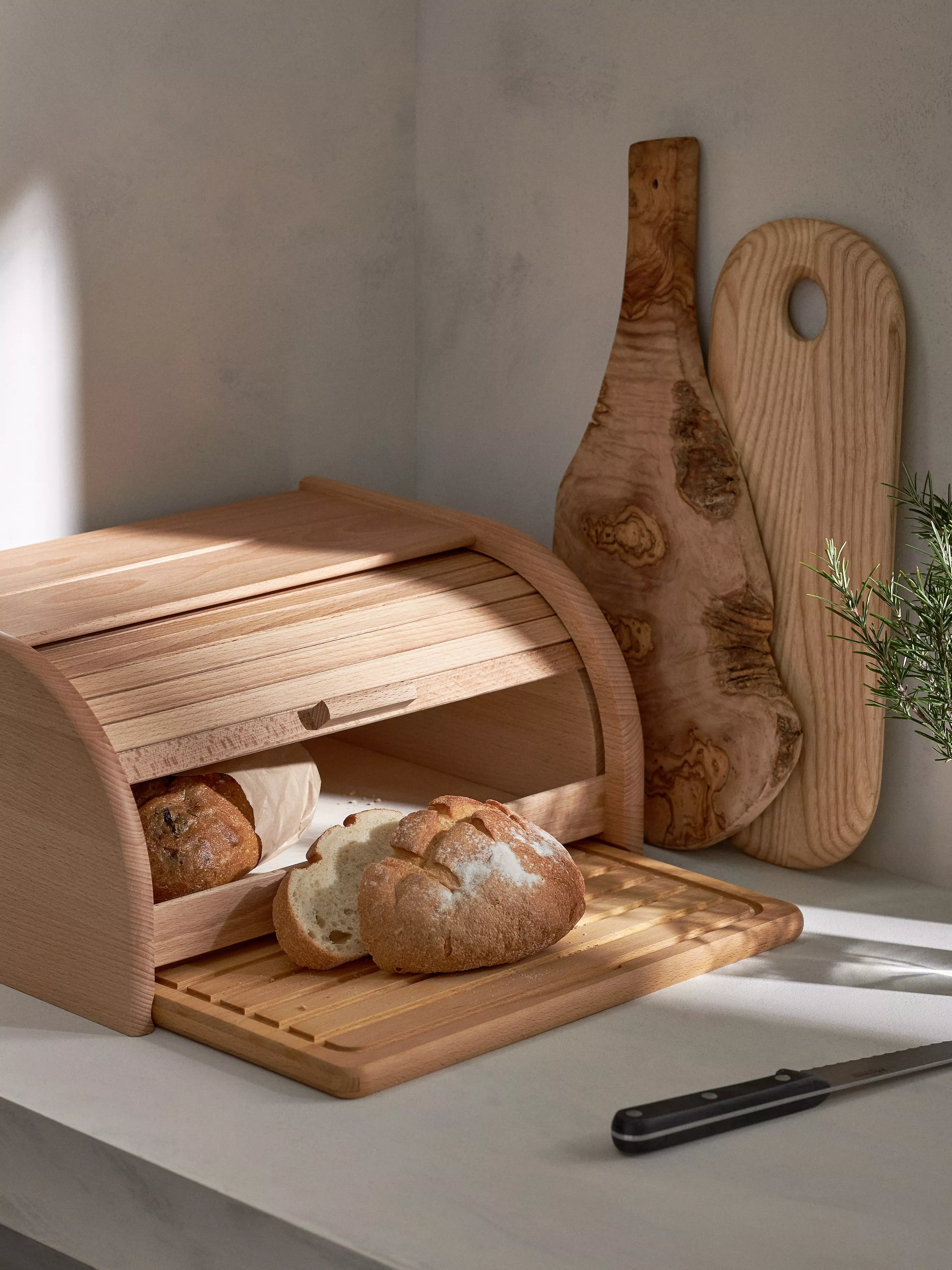 Wooden bread bin with sourdough loaf 