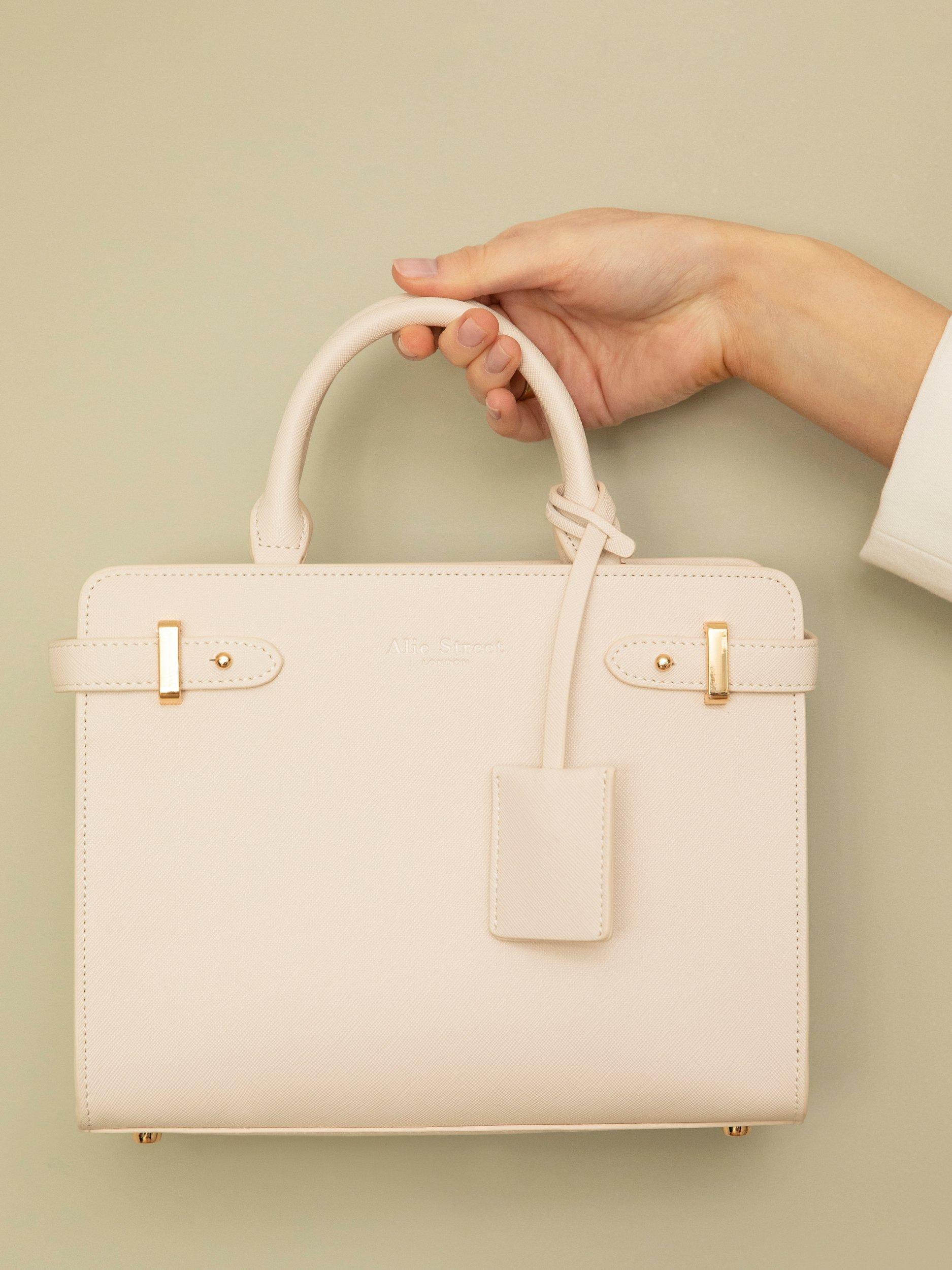 Product image 9 of 9, which shows Alie Street Derby Handbag, Nude