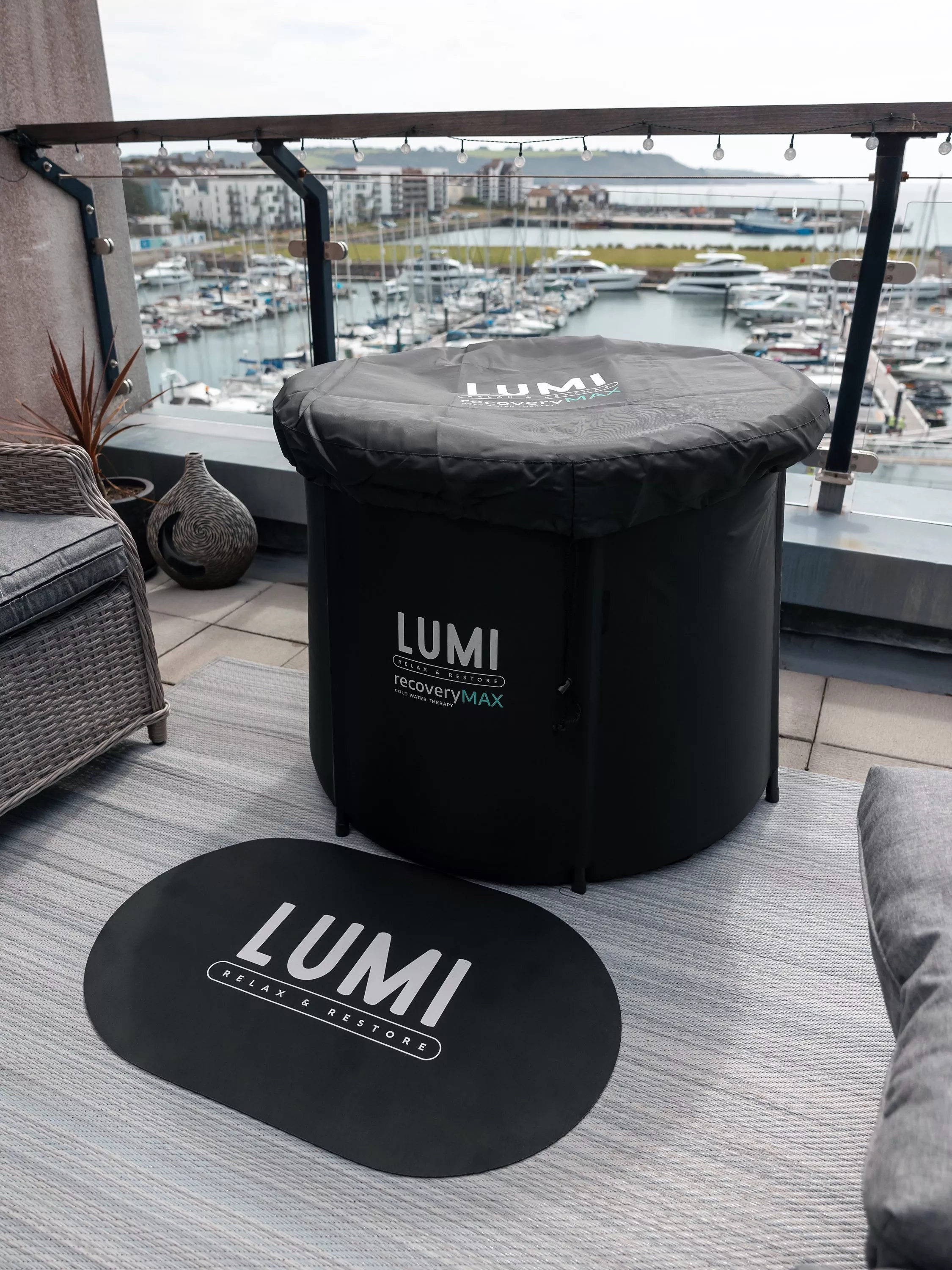 An ice bath on a balcony over looking a harbour