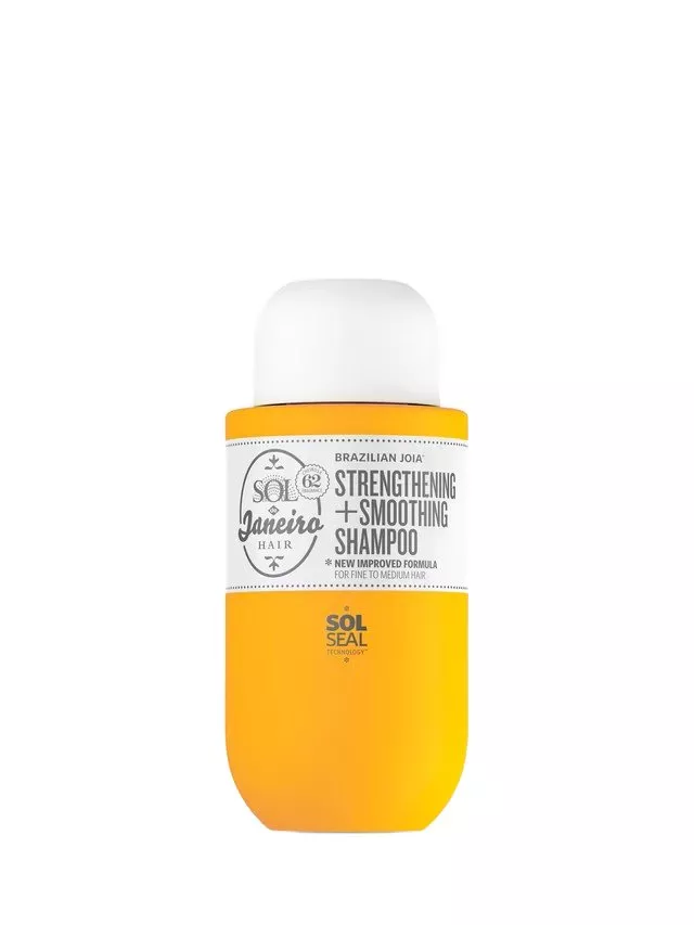 Yellow bottle of Sol de Janeiro Strengthening + Smoothing Shampoo with a white cap and label detailing.