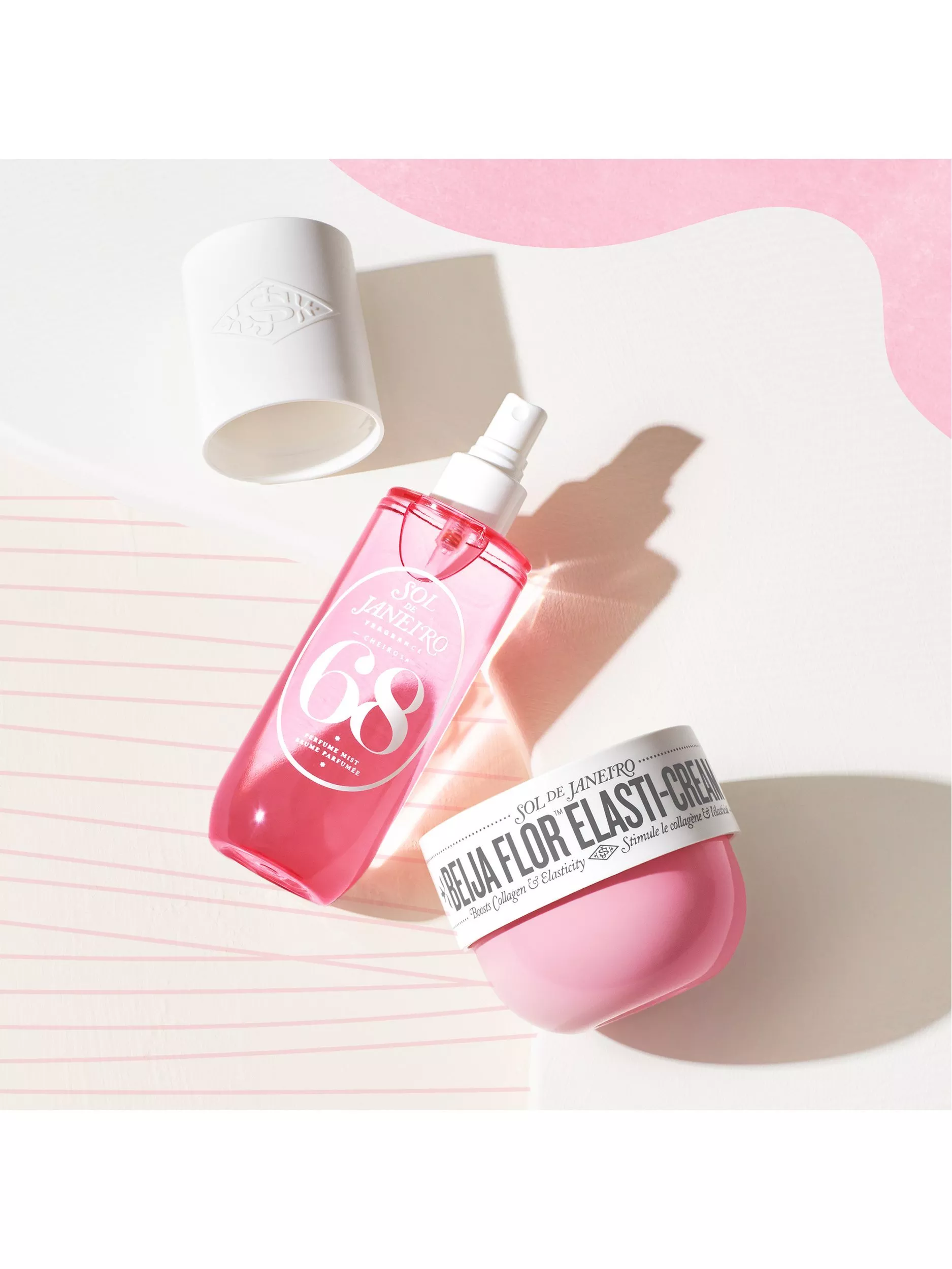 Sol de Janeiro Cheirosa 68 perfume mist and Beija Flor Elasti-Cream jar on a pastel backdrop, flat lay.