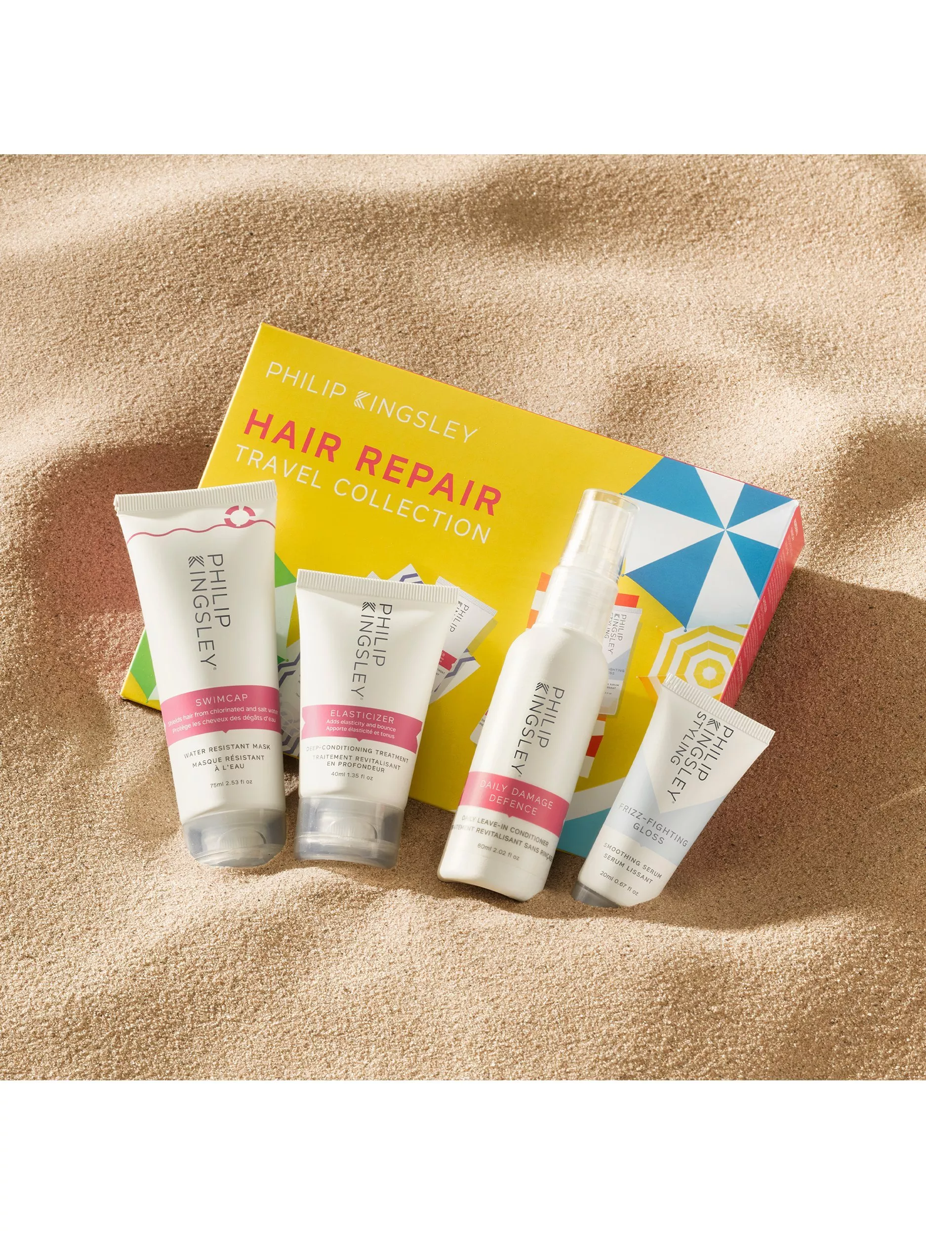 Moroccanoil products displayed on a marble surface with a leather pouch, featuring shampoo, conditioner, and hand cream.