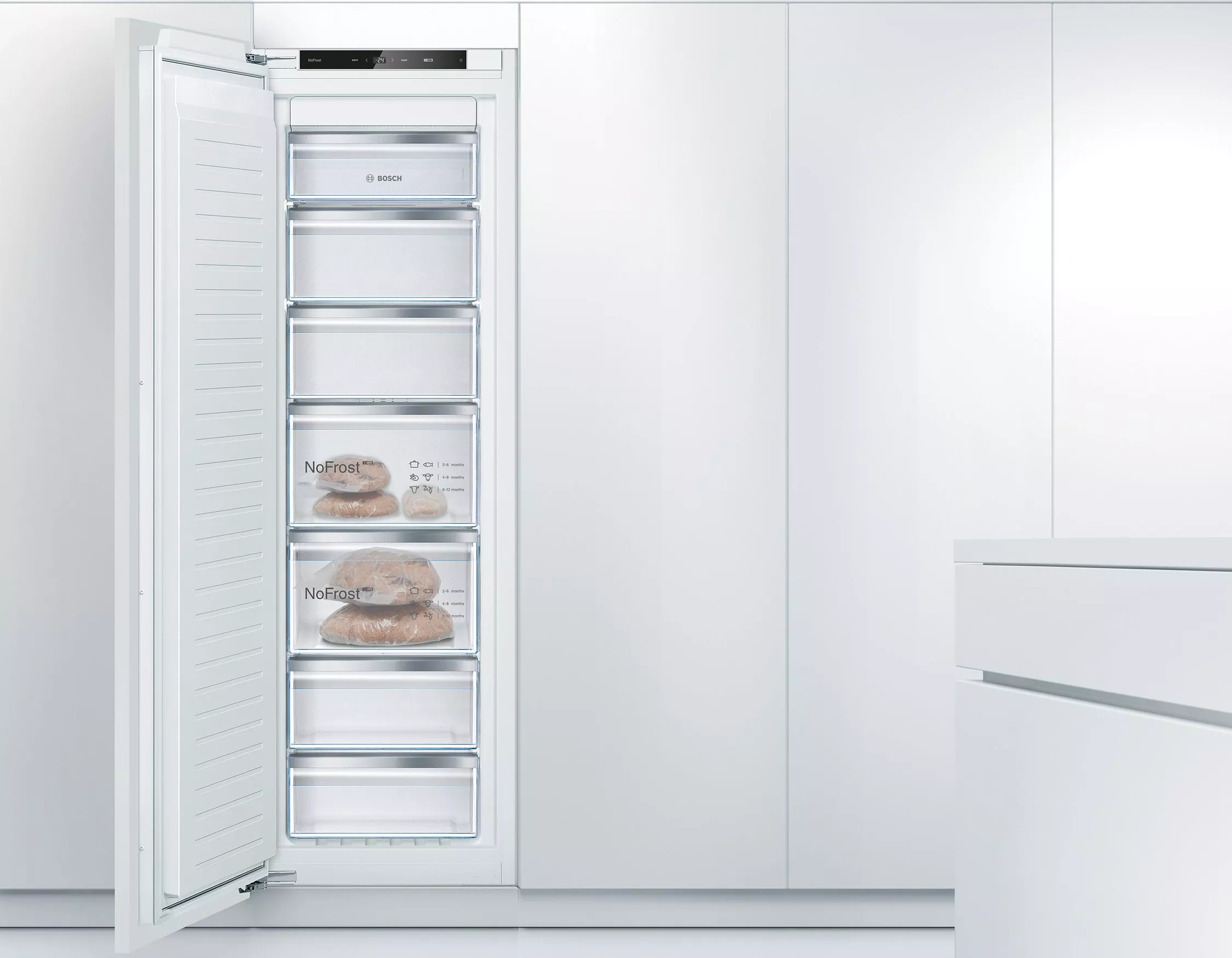 Bosch integrated NoFrost freezer with open door, showing drawers and digital control panel for frozen storage