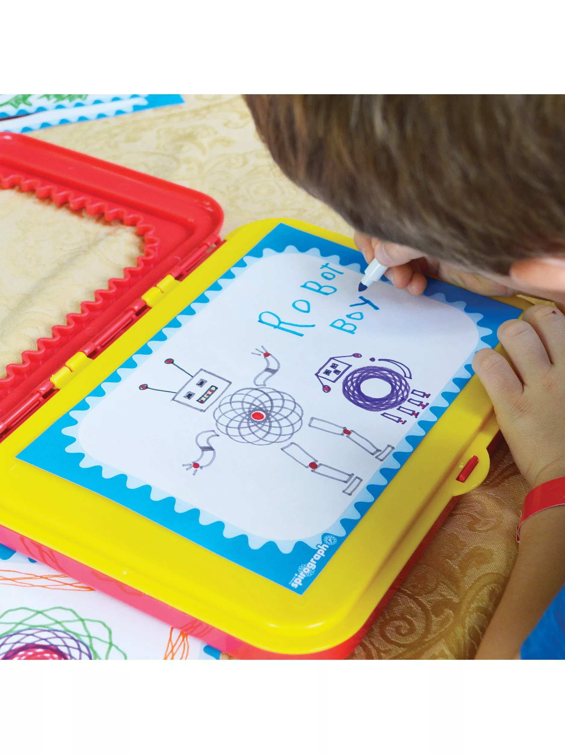 Child drawing on a spirograph design set