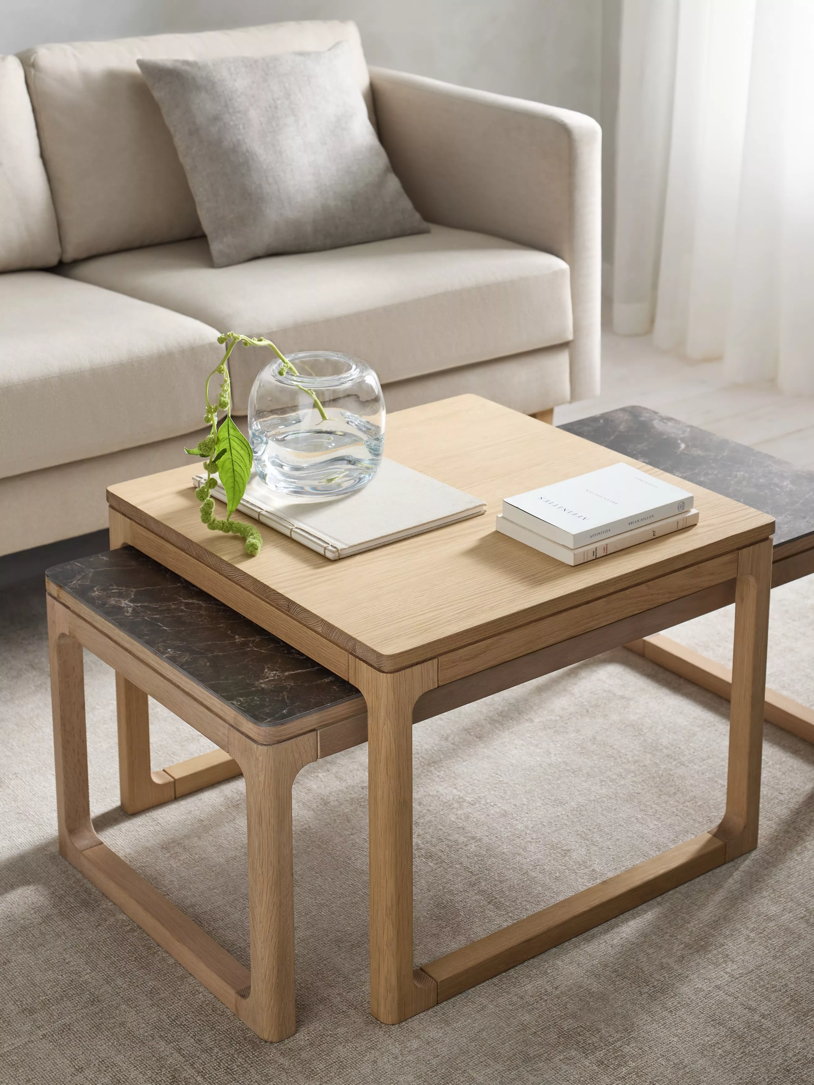 Scandi dining table with chairs and table made up with a vase, plates, glasses and a candle