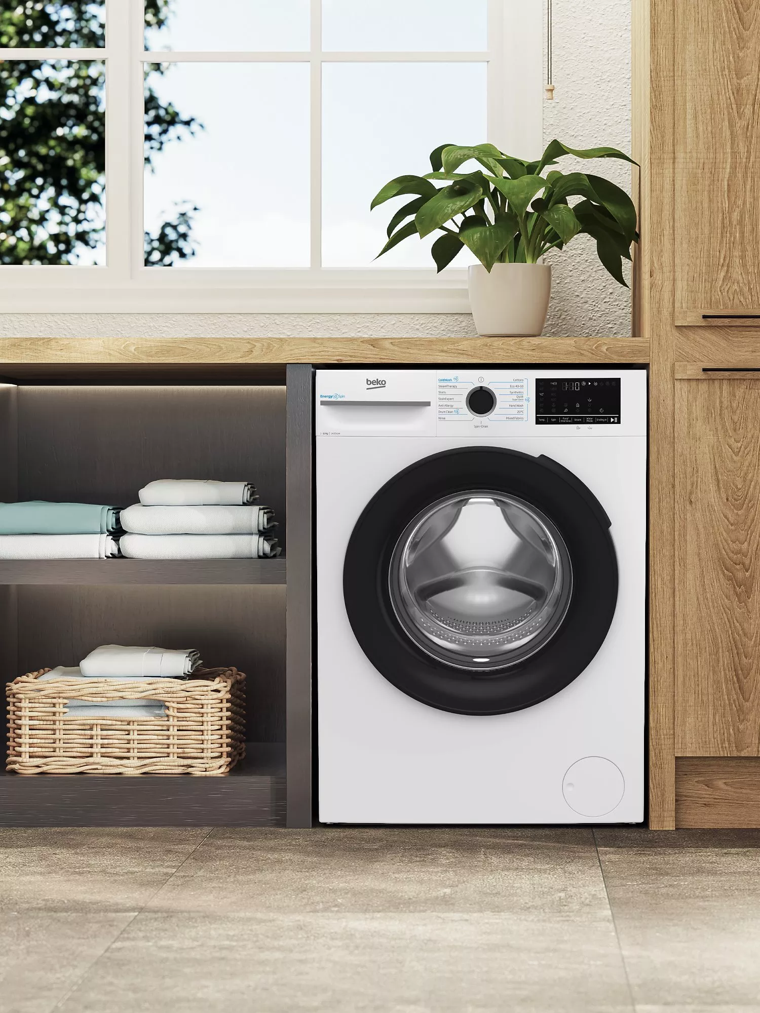 Modern laundry room with a sleek washing machine, wooden cabinets, and a potted plant near a bright window.