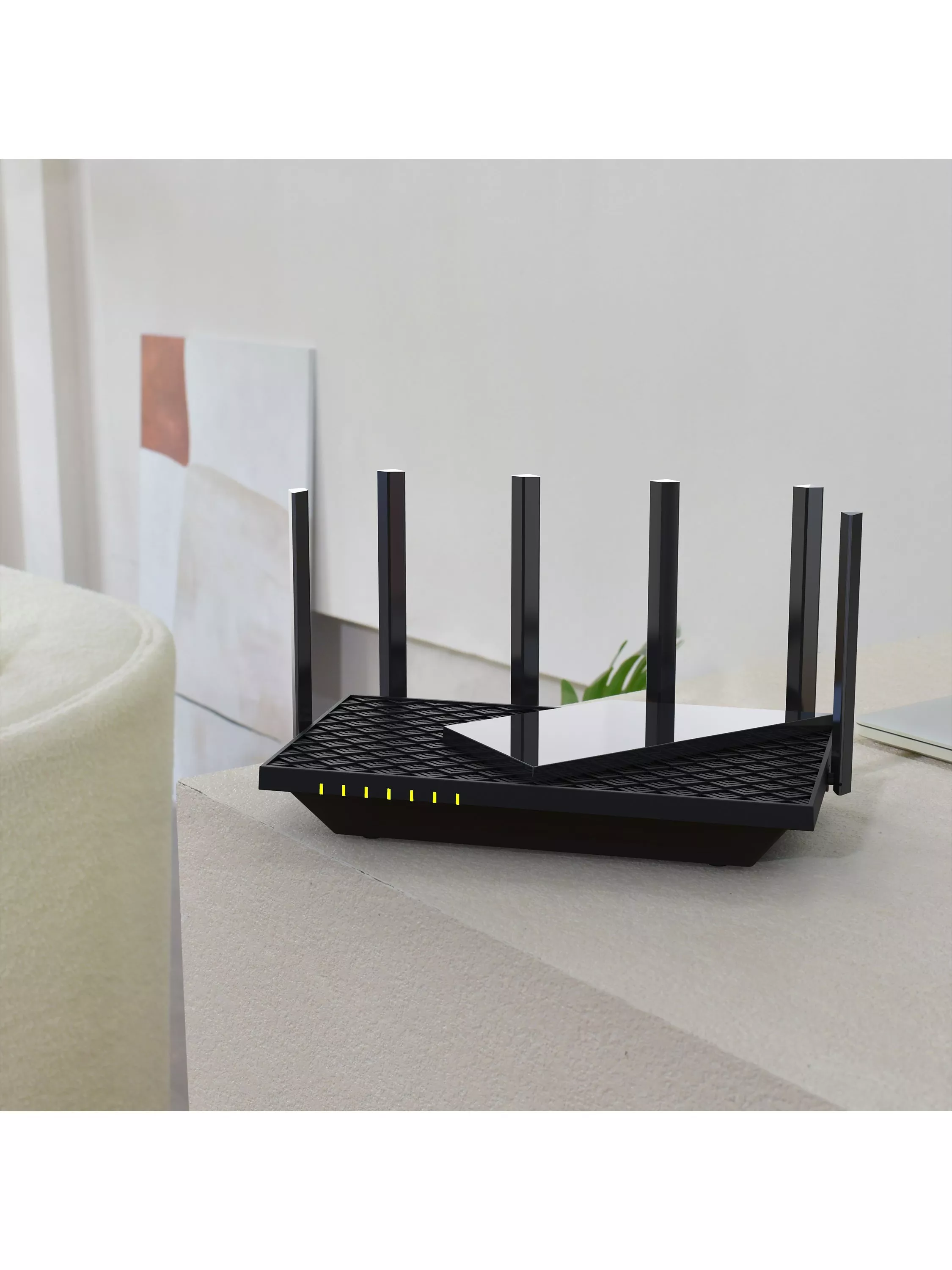 Black Wi‑Fi 6 router with six antennas and LED lights on a table in a modern minimalist living room