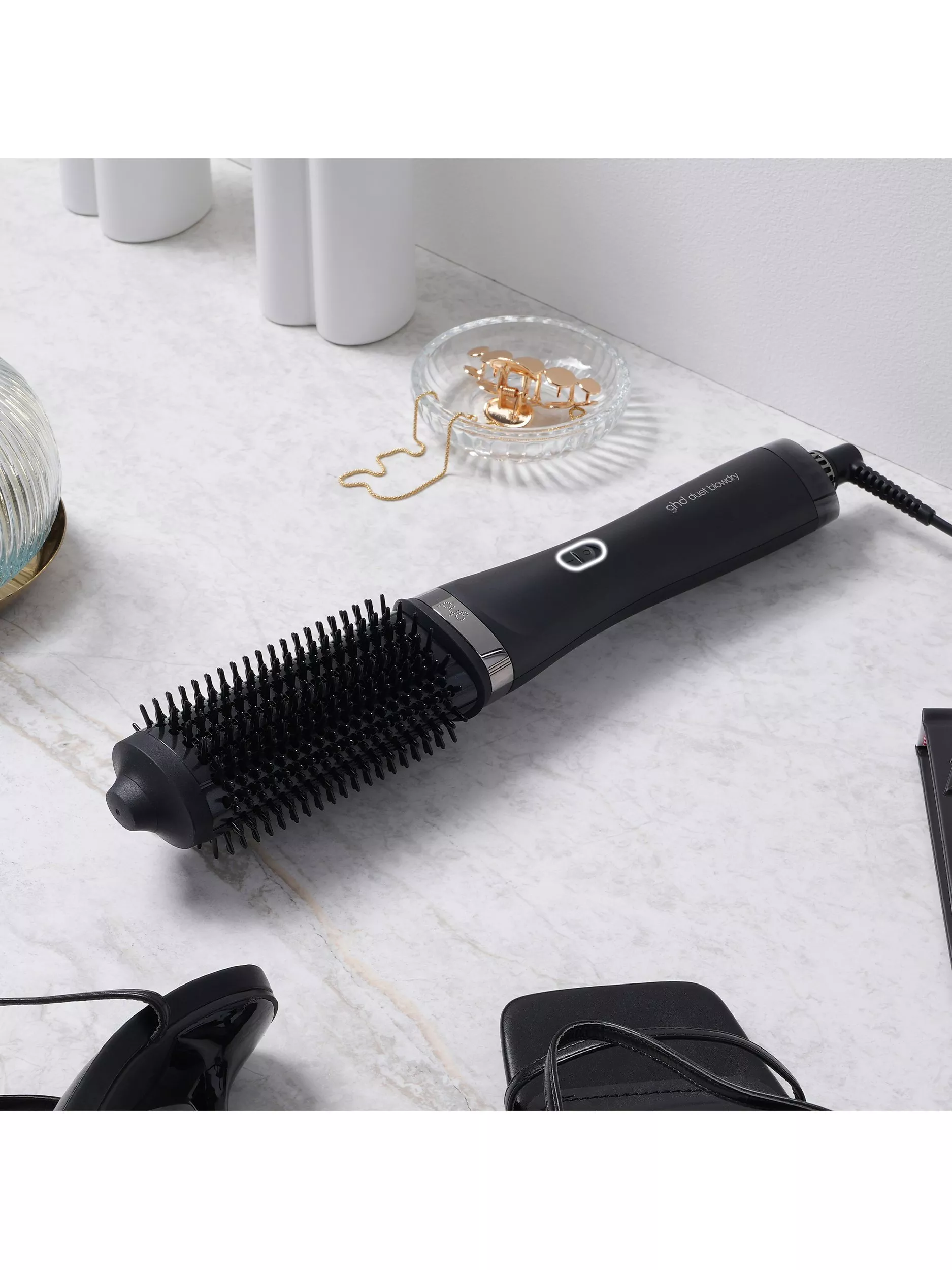 Hair styling tool set with a copper and black finish, featuring a wand, various attachments, and a storage case.