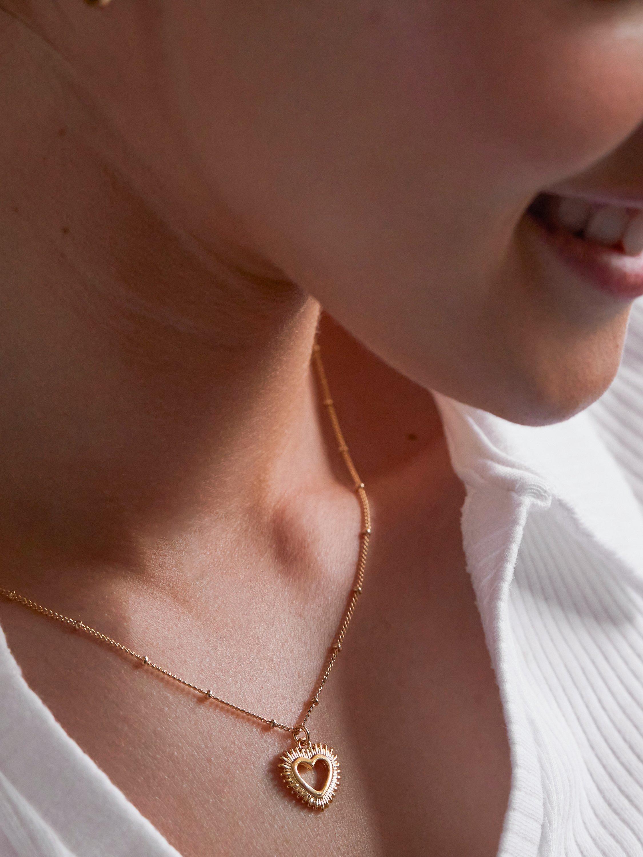 Product image 3 of 4, which shows Estella Bartlett Heart Burst Pendant Necklace, Gold