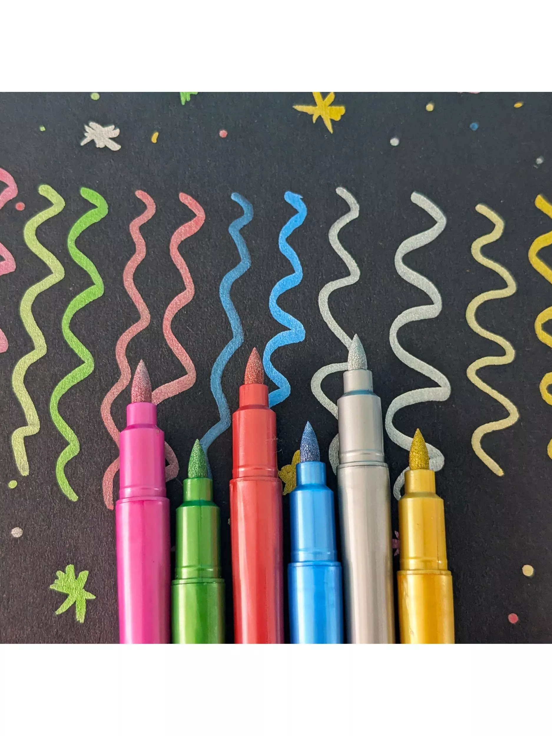 Multiple highlighter colours on a bright pink background