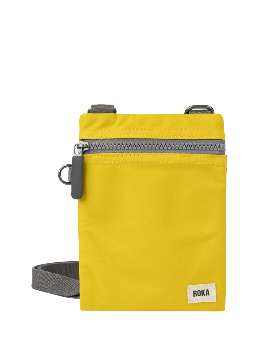 Product image 1 of 6, which shows ROKA London Chelsea Recycled Nylon Crossbody Pocket Bag, Mustard