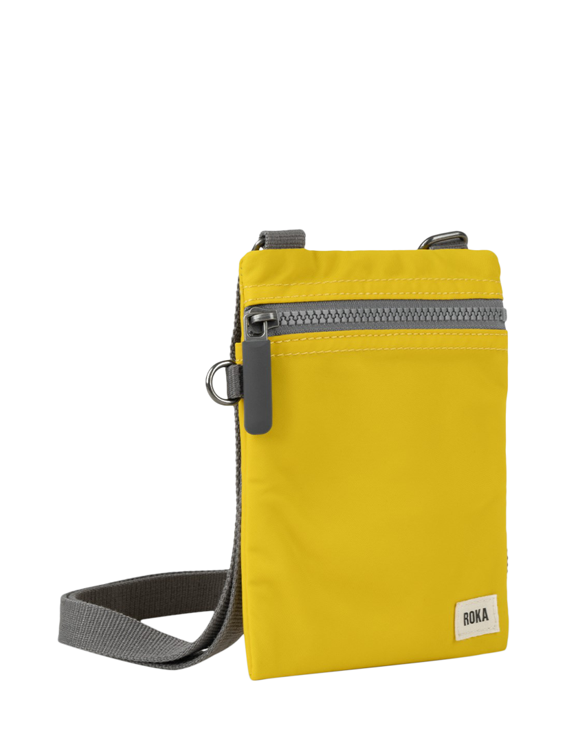 Product image 2 of 6, which shows ROKA London Chelsea Recycled Nylon Crossbody Pocket Bag, Mustard