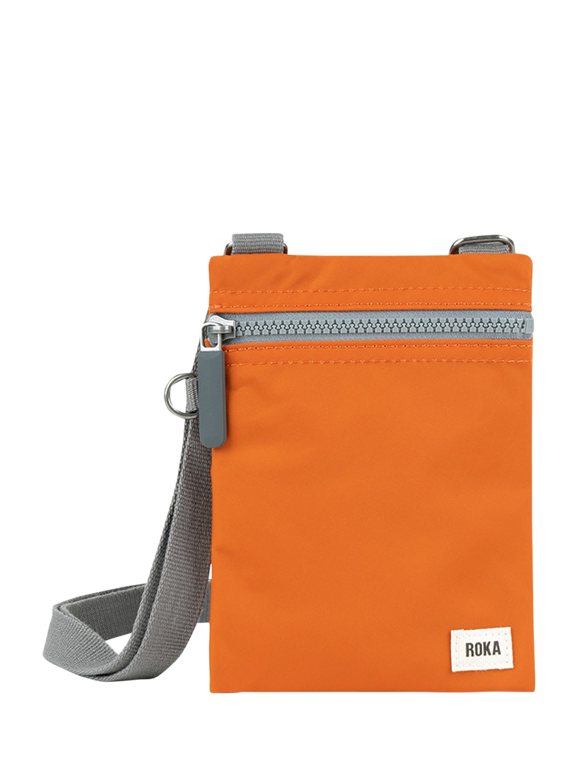 Product image 1 of 6, which shows ROKA London Chelsea Recycled Nylon Crossbody Pocket Bag, Burnt Orange