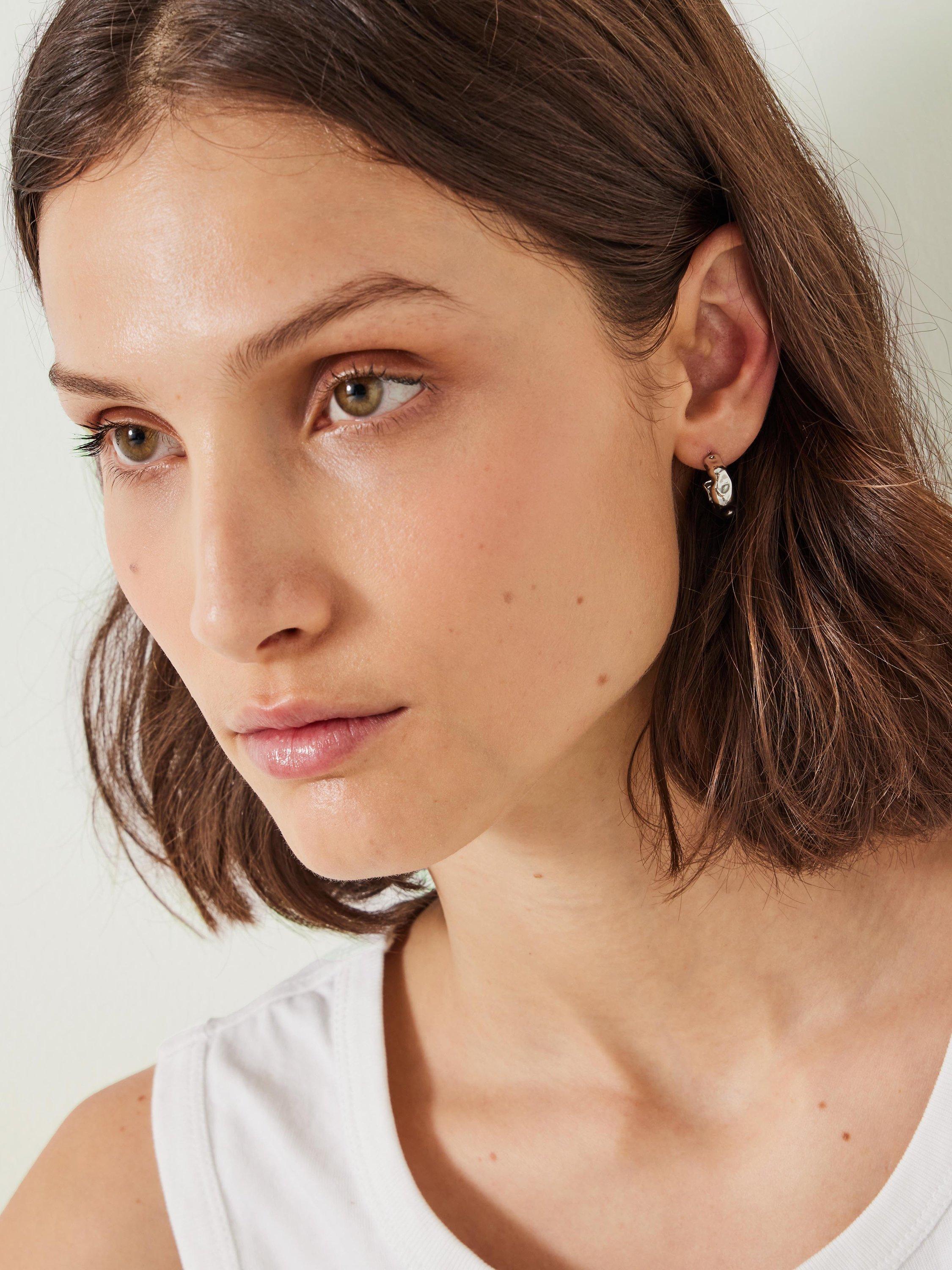 Product image 2 of 4, which shows HUSH Wave Huggie Demi Hoop Earrings, Silver