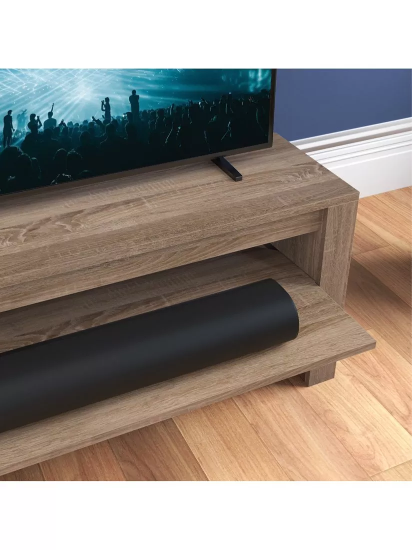Close-up of a TV stand with a soundbar on it