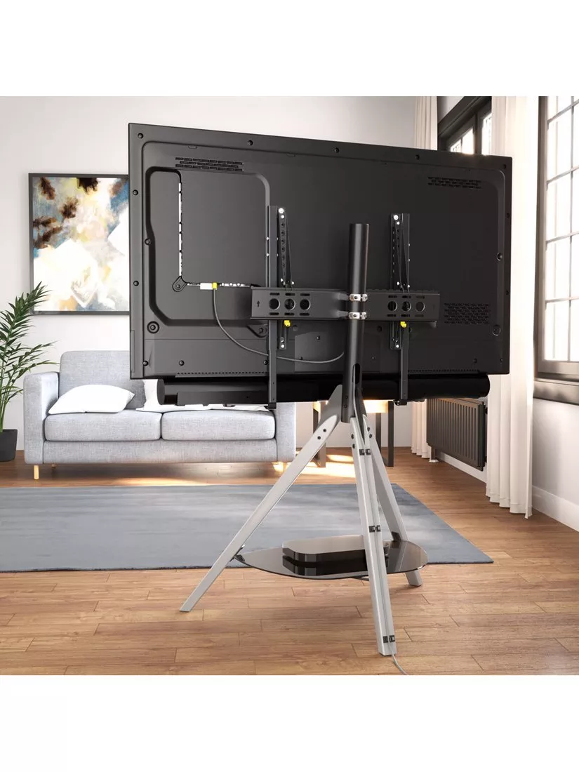 Rear view of TV on stand showing mounts and cables