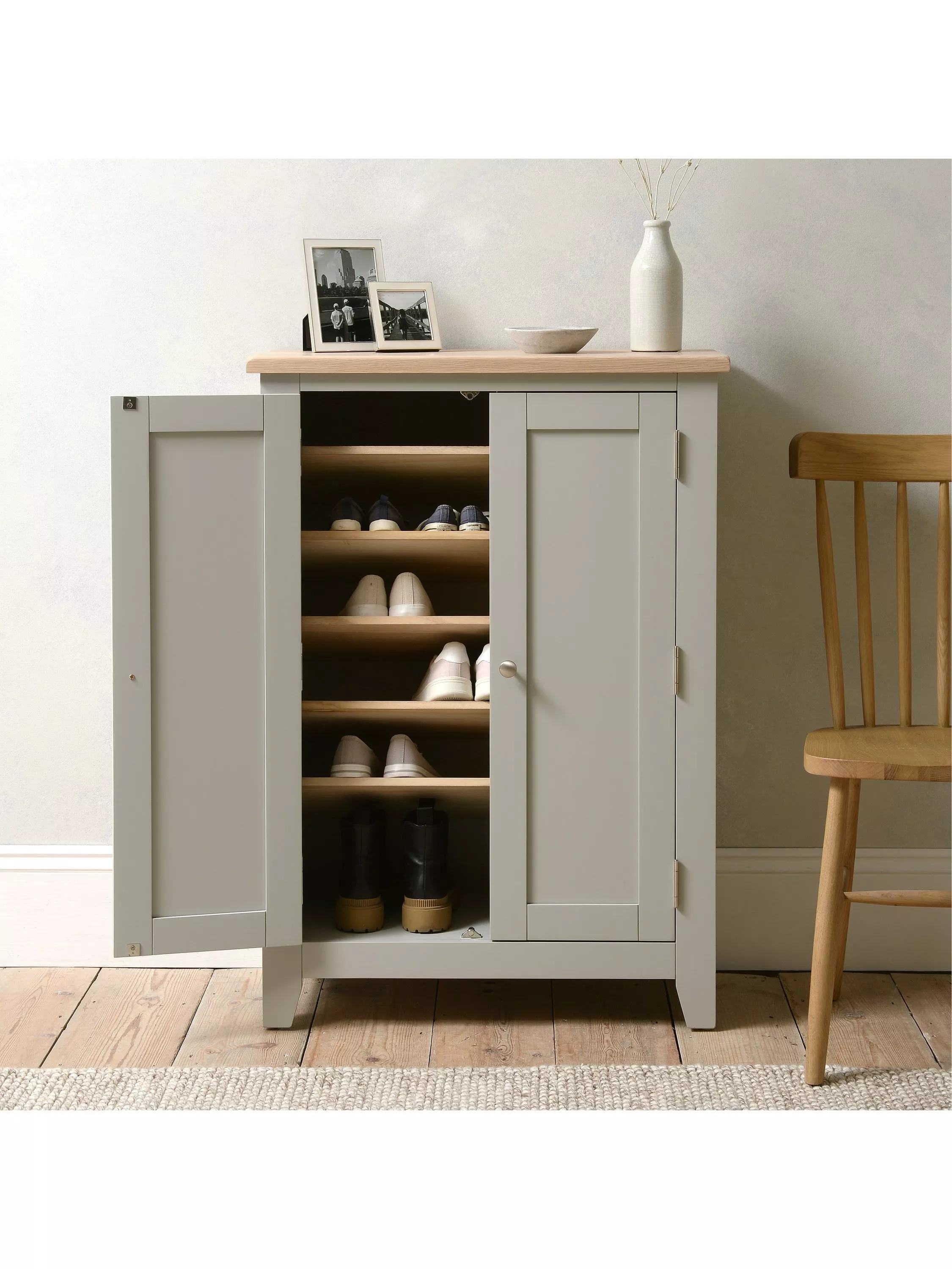 Wooden shoe cabinet with trainers and sandals inside