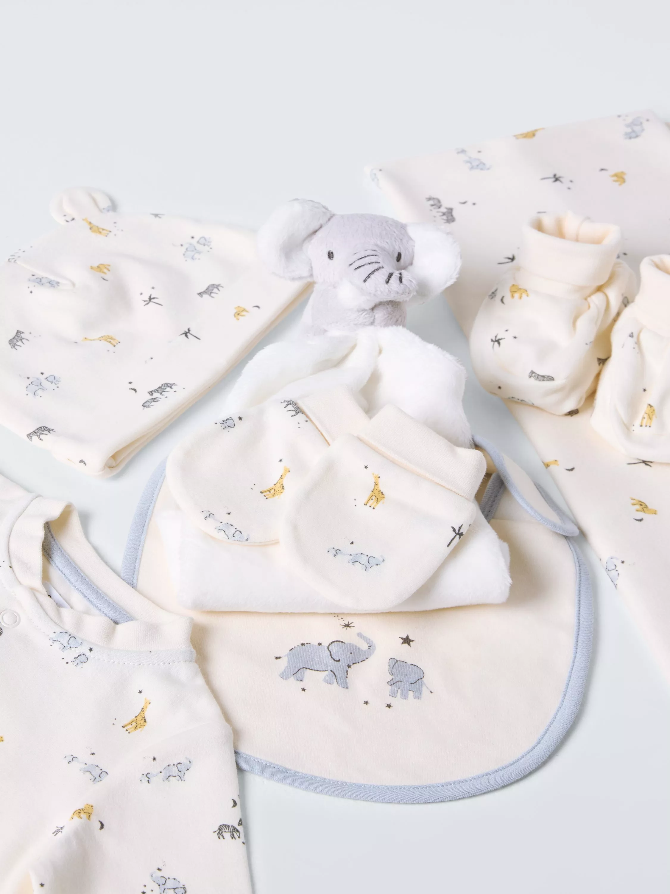 Selection of baby clothing with safari animals printed on them